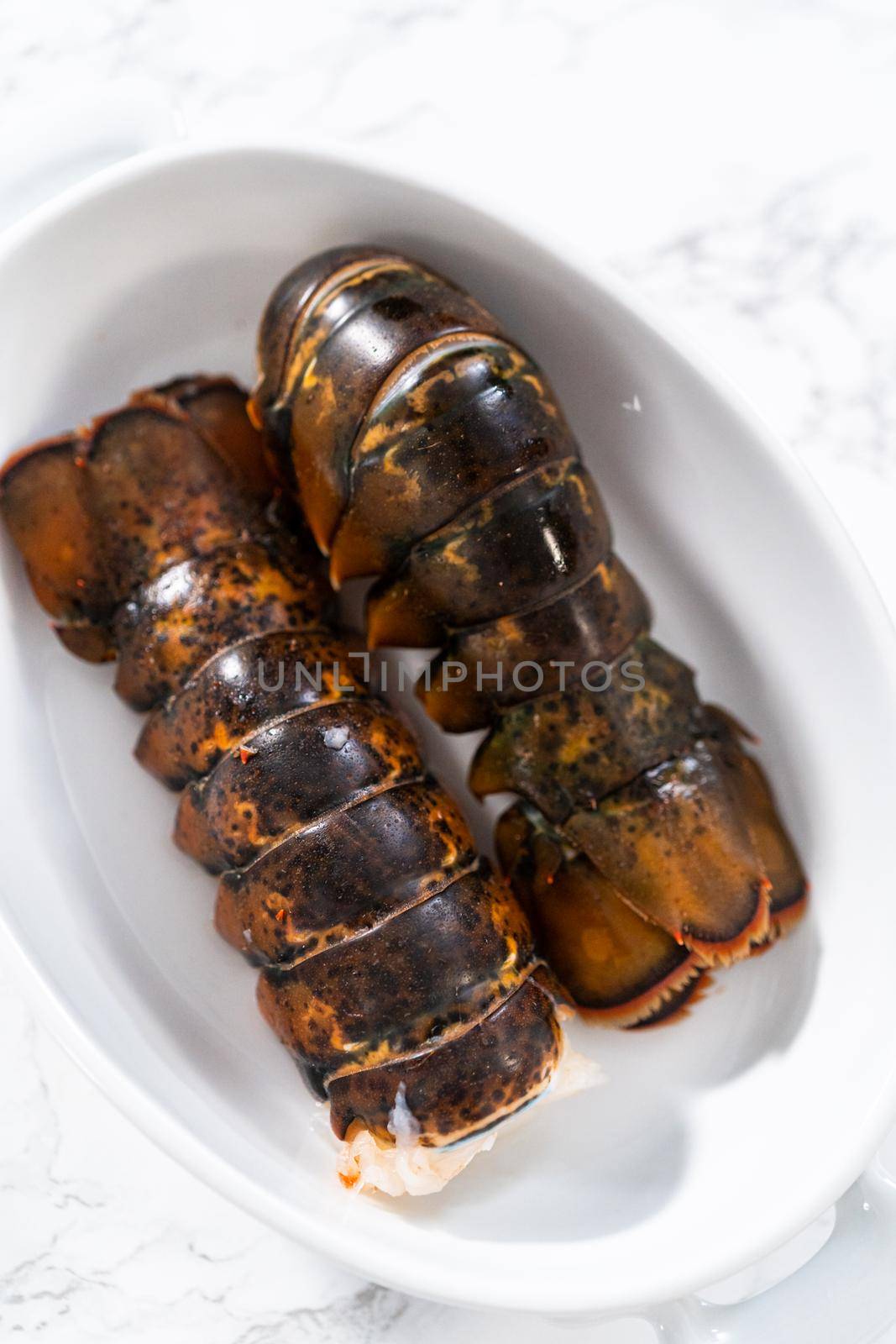 Preparing raw lobster tails to make garlic lobster tails.
