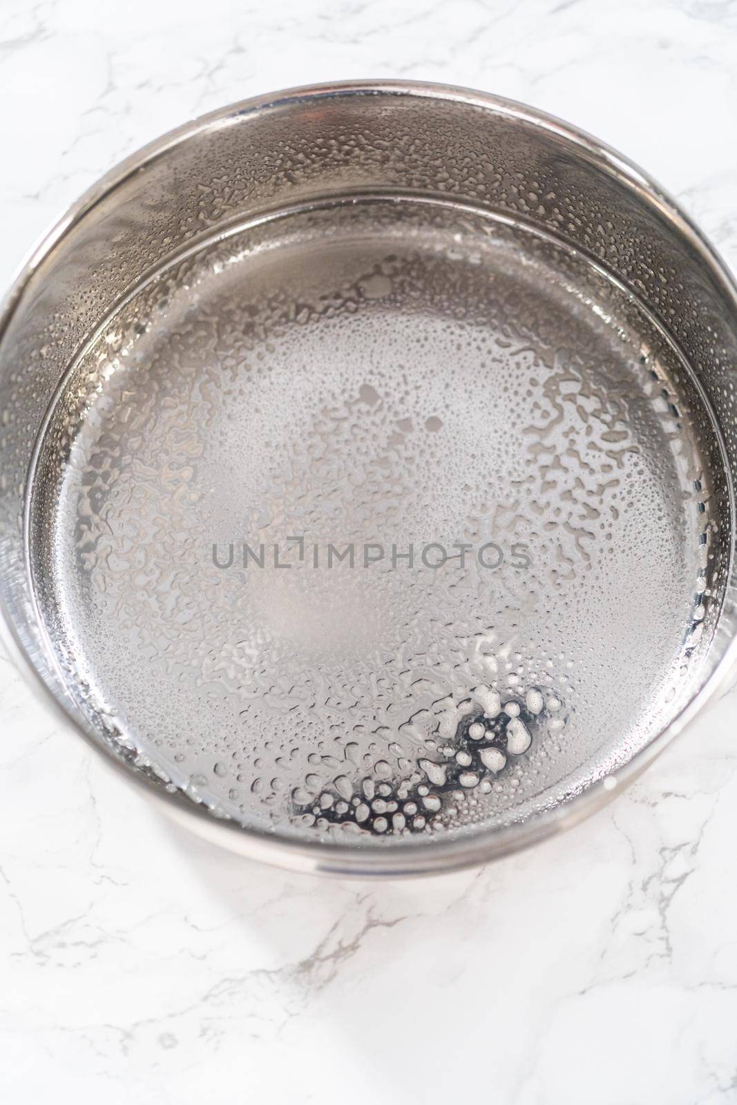 Greasing pressure cooker insert with cooking spray oil to cook no-peel hard-boiled eggs.