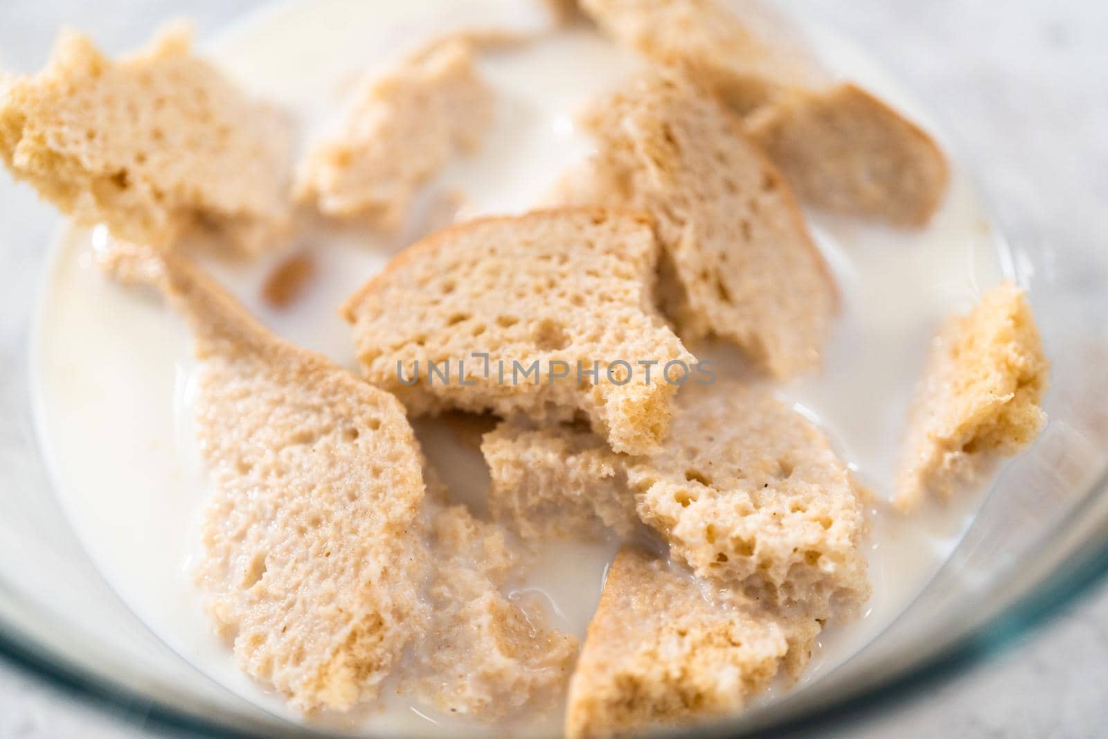Soaking stale bread in milk to make meatloaf.