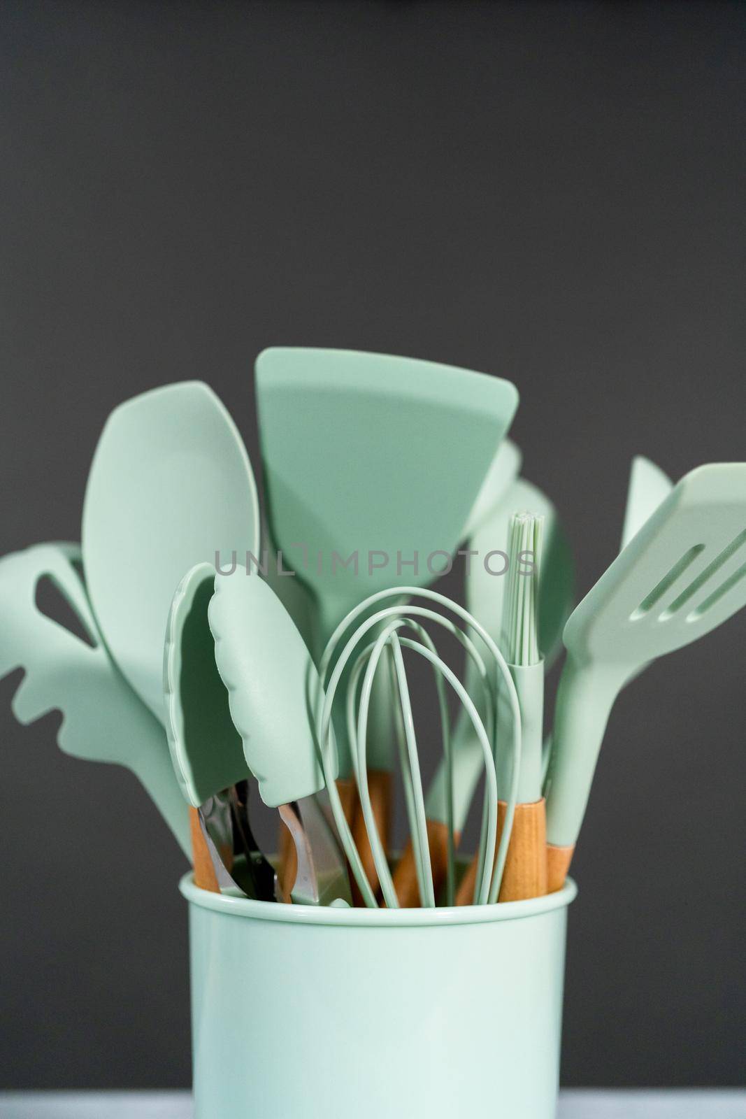 Silicone cooking utensils with wooden handle.