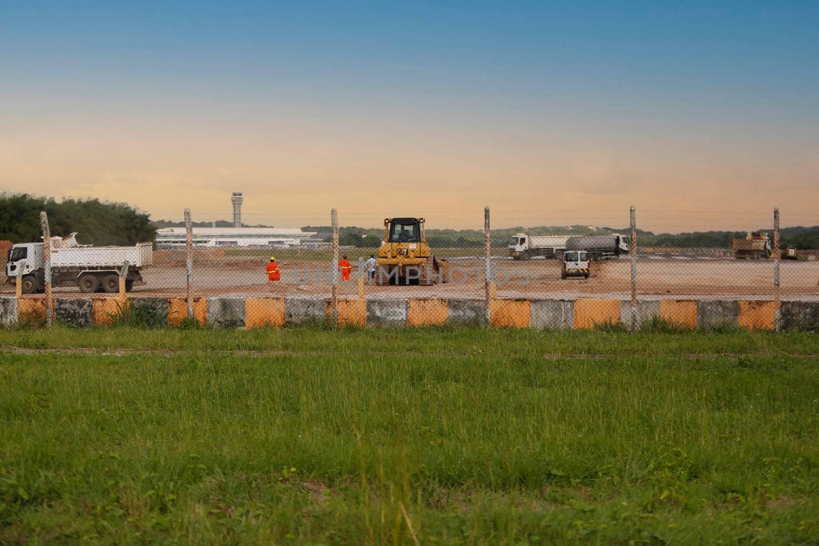 salvador, bahia, brazil - june 14, 2018: Workers and machines are seen during renovation work on the runway at the airport in the city of Salvador.