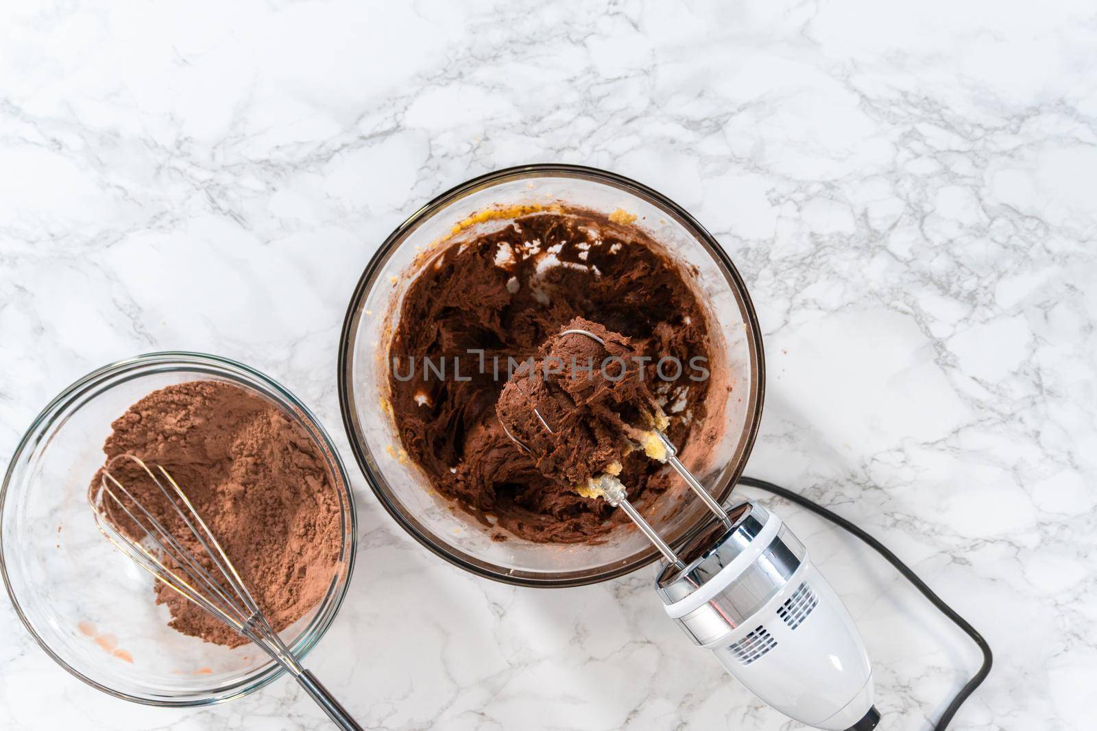 Flat lay. Mixing ingredients in a large glass mixing bowl to bake peppermint white chocolate cookies.