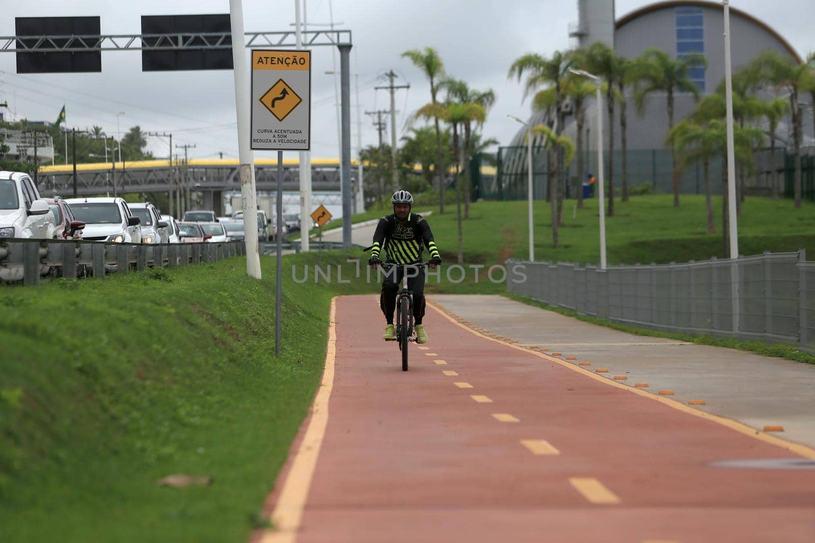 salvador, bahia, brazil - april 2, 2019: Person riding a bicycle on a bike path on Avenida Luiz Viana, along line 2 of the subway in the city of Salvador.