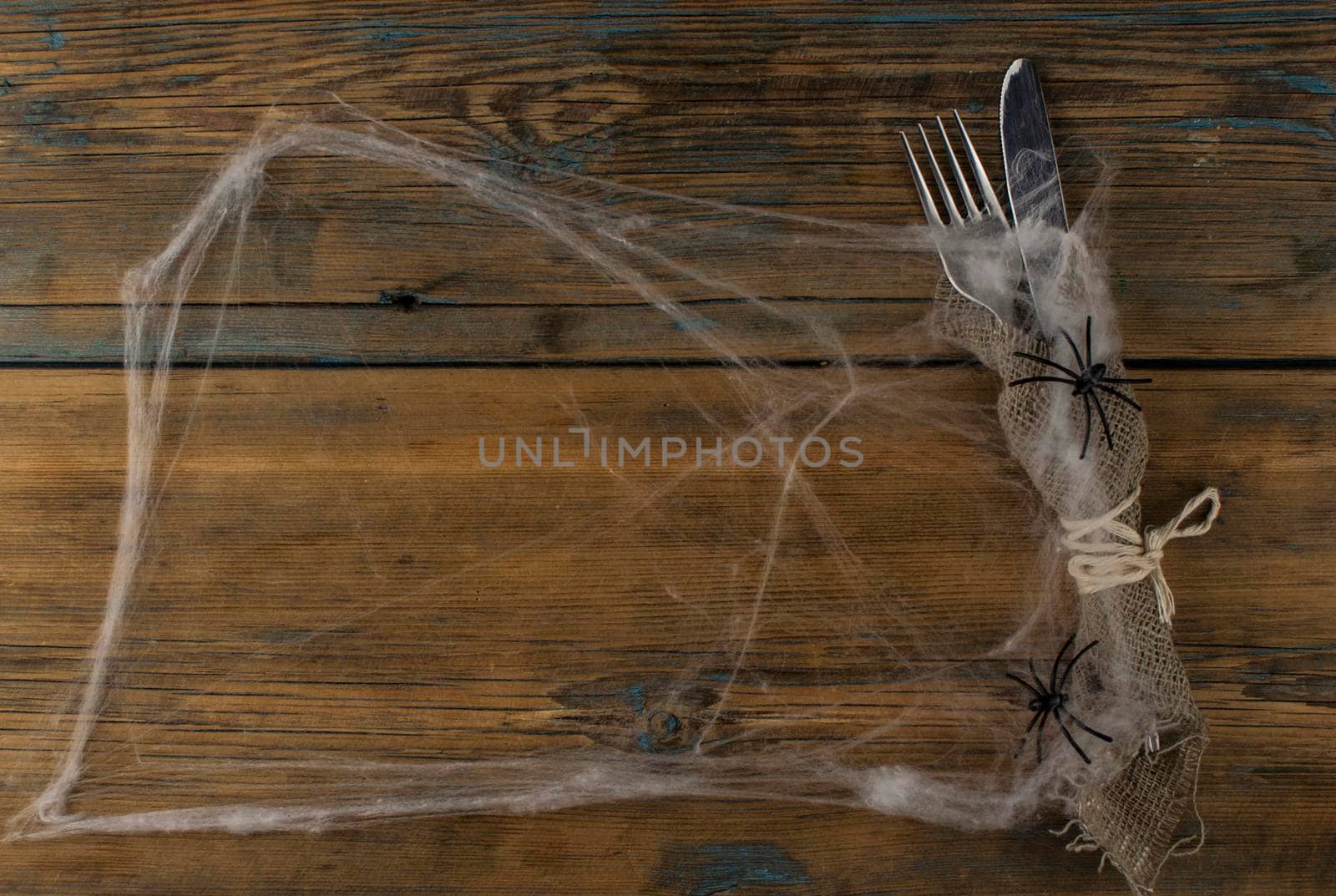 Halloween table setting on old rustic wooden table holiday card template copy space. Menu card