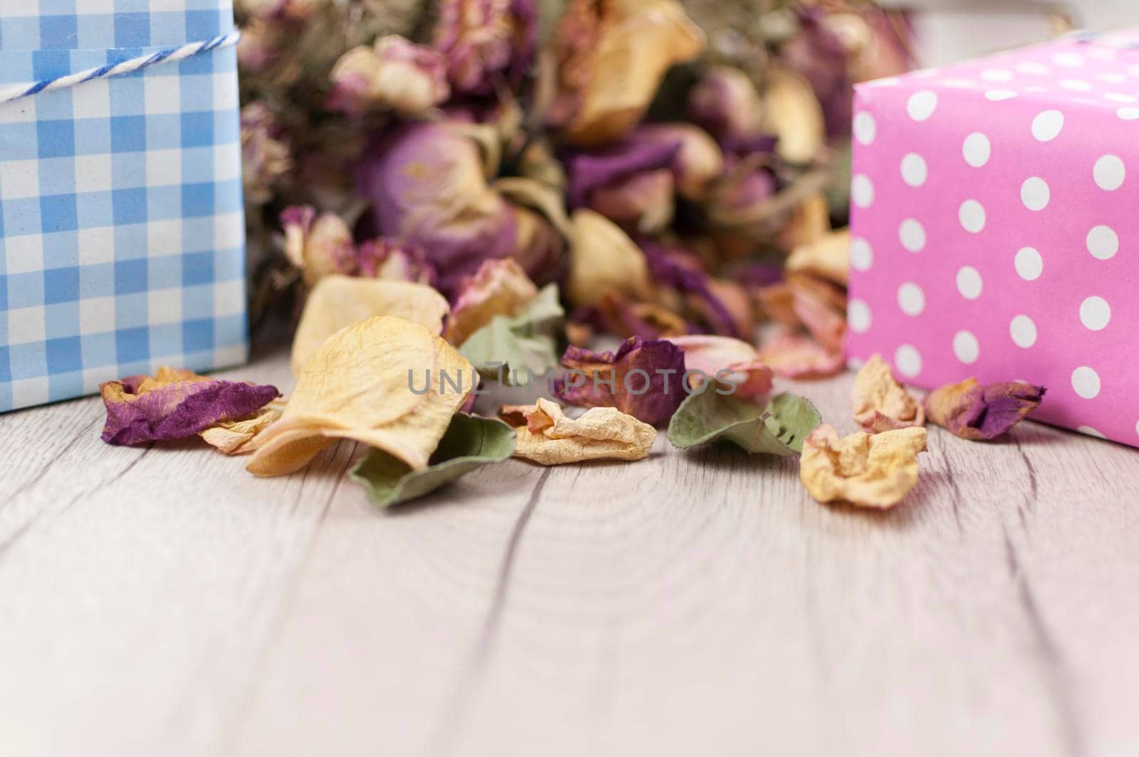 bouquet dried roses with gift box on wood background with copy space