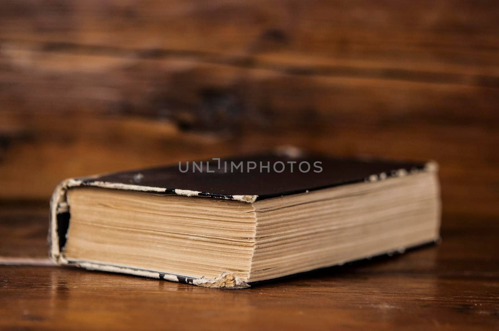 Close up of old book on wooden table