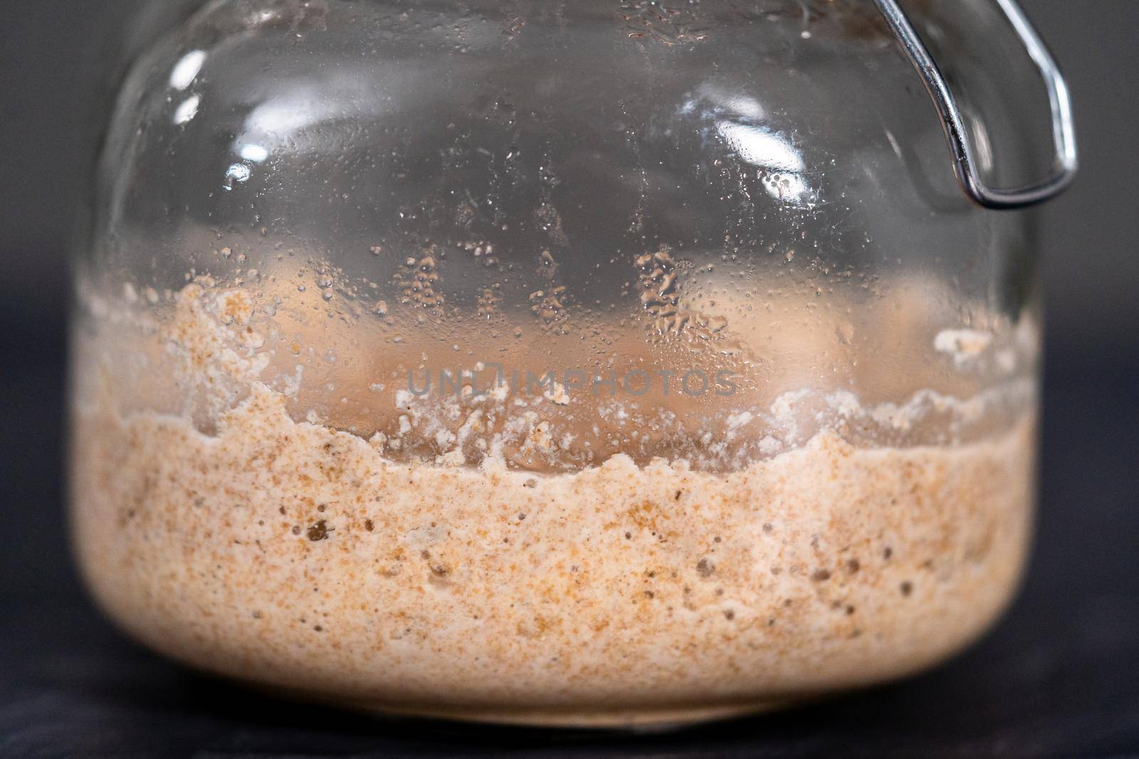 Homemade wheat sourdough starter in a glass mason jar.