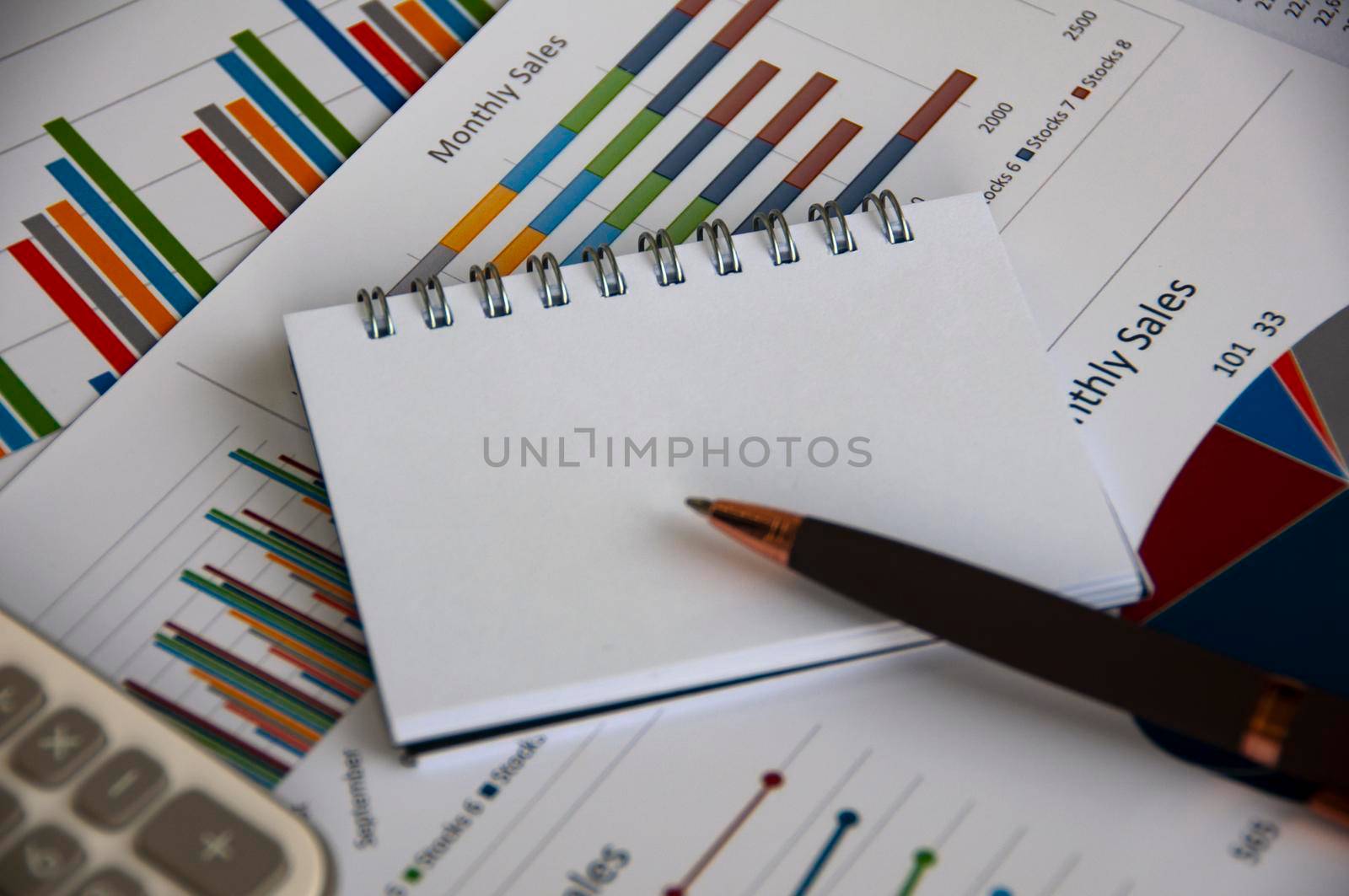 Blank notepad with customizable space for text with graph analysis background. Copy space and business analysis concept.