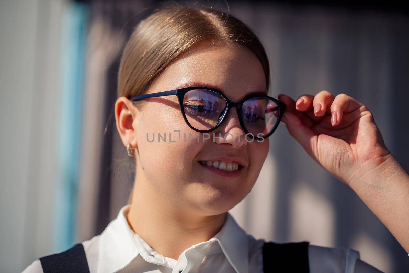 Confident business woman boss standing in modern office wearing glasses, female leader, business owner thinking about future success, planning new opportunities