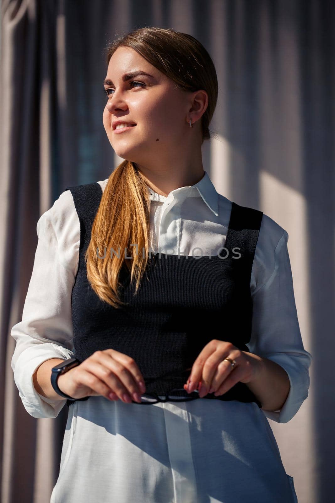 Confident business woman boss standing in modern office, female leader, business owner thinking about future success, planning new opportunities
