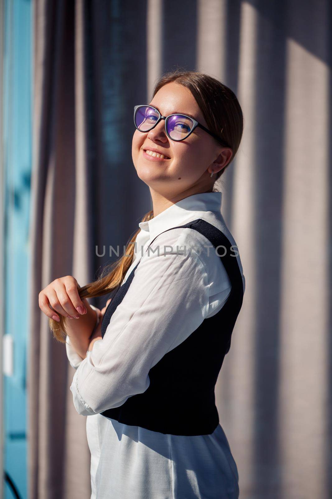 Confident business woman boss standing in modern office wearing glasses, female leader, business owner thinking about future success, planning new opportunities