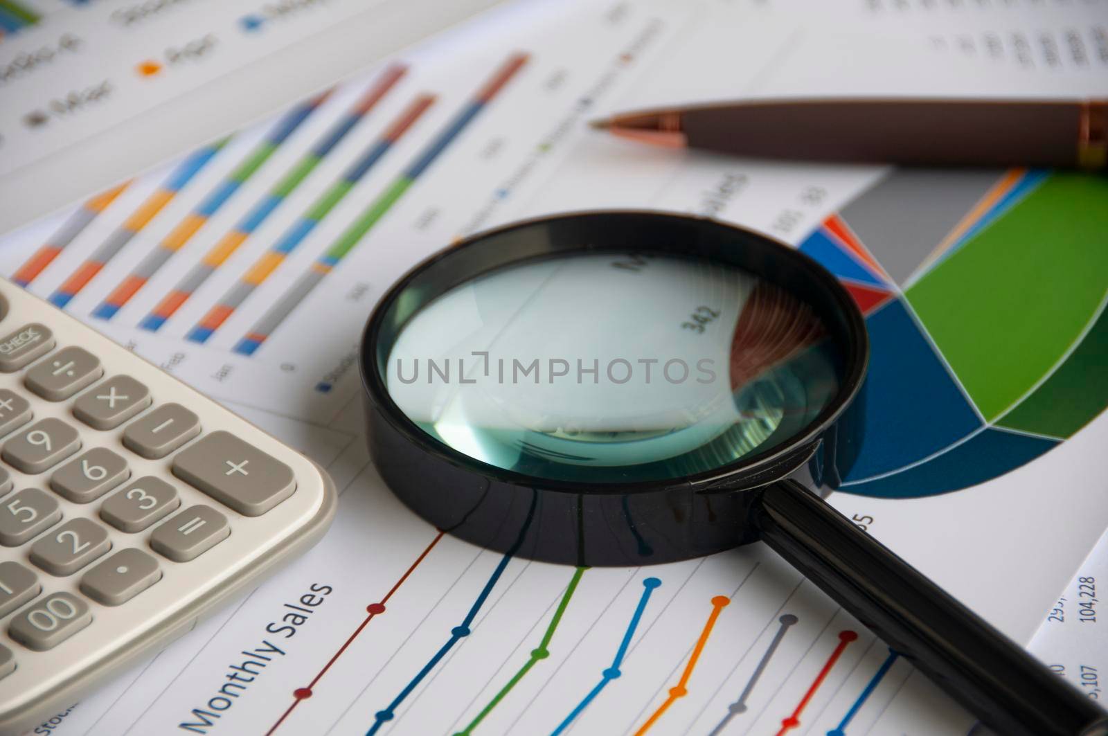 Magnifying glass on graph analysis. Copy space and business analysis concept.