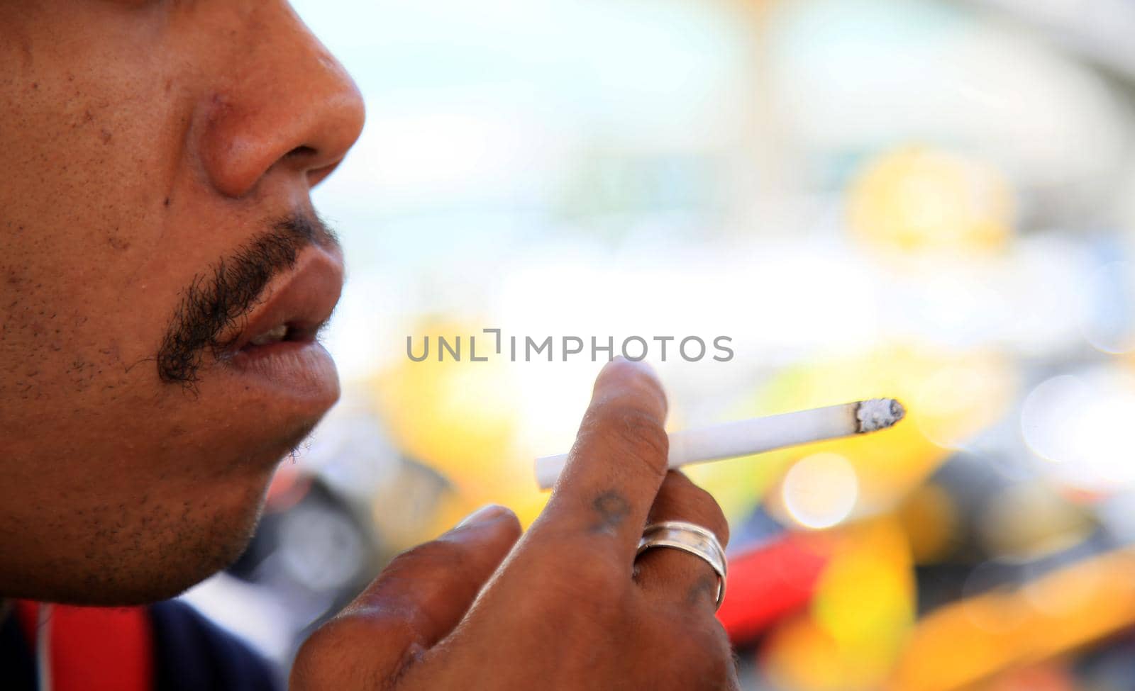 salvador, bahia, brazil - august 12, 2021: Man is seen smoking cigarette on the street in Salvador city.