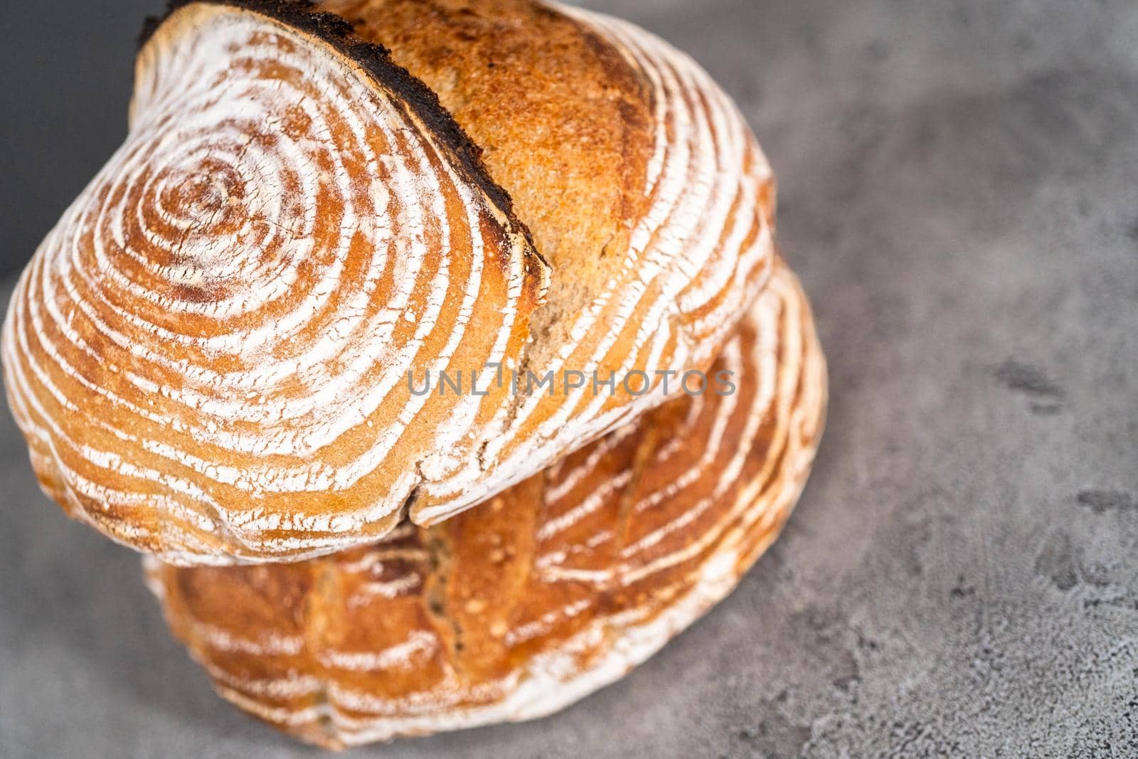 Freshly baked loaf of a wheat sourdough bread with marks from bread proofing basket.