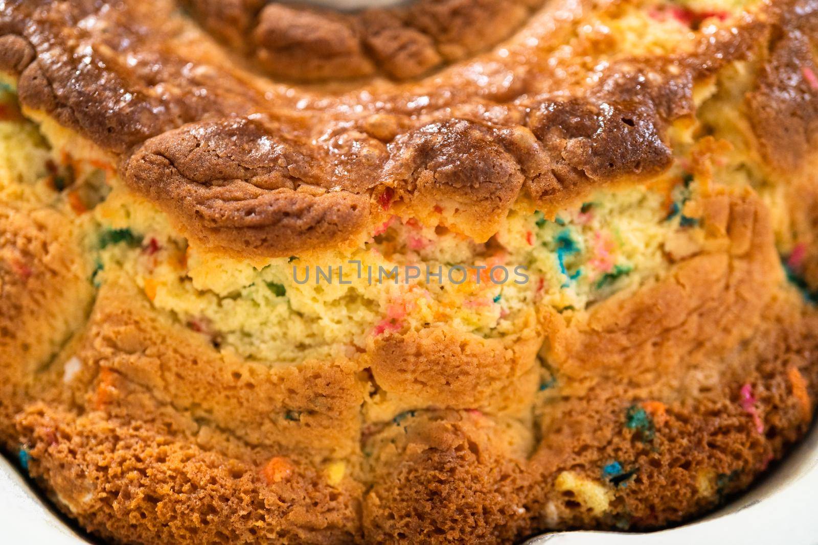 Close up view. Cooling freshly baked funfettti bundt cake on a wire rack.