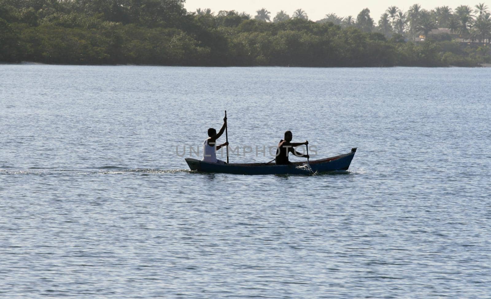 caravelas, bahia / brazil - september 11, 2008: people are seen in a rowboat in the waters of the Caravalas river in the city of Caravelas in southern Bahia.