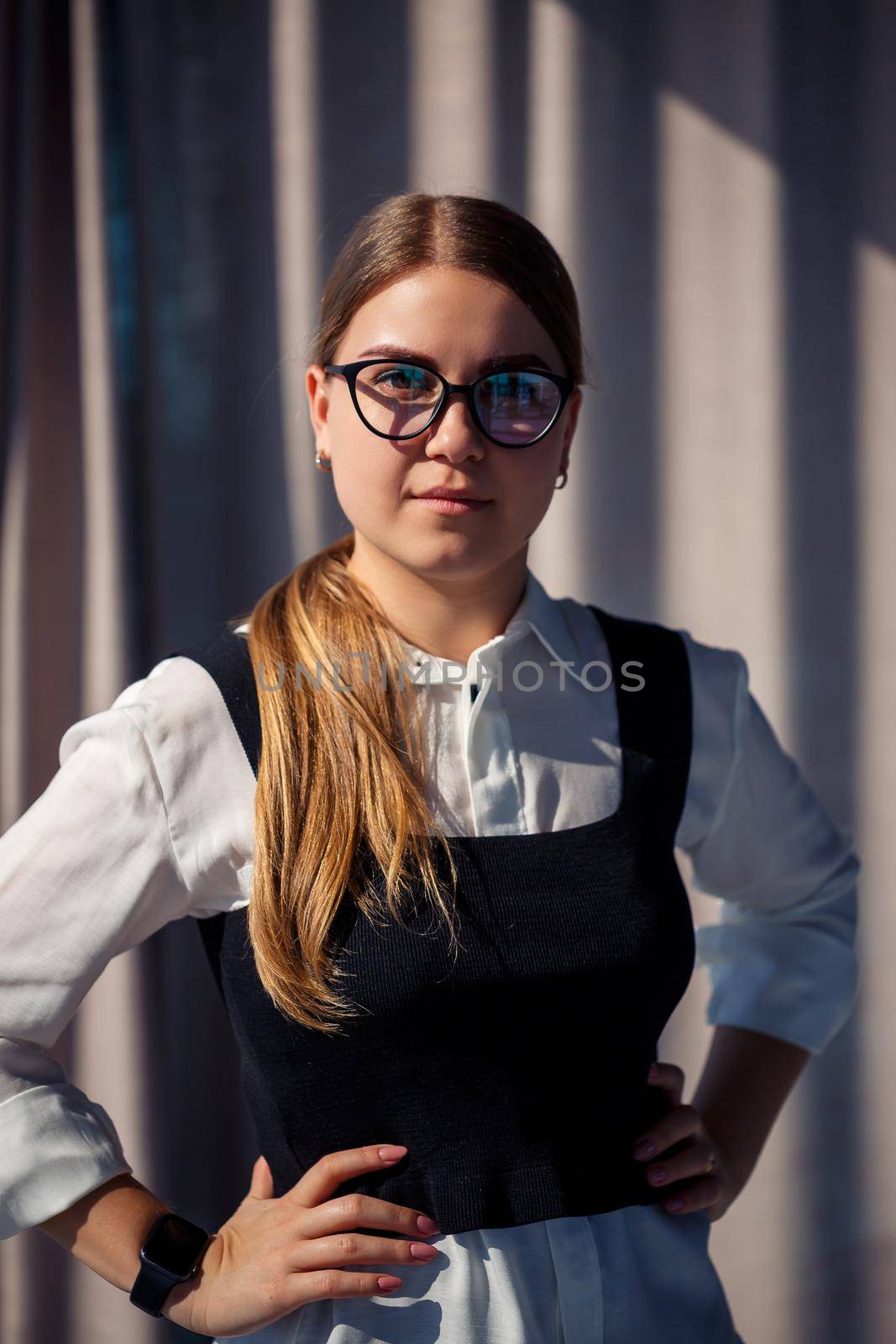 Confident business woman boss standing in modern office wearing glasses, female leader, business owner thinking about future success, planning new opportunities by Dmitrytph