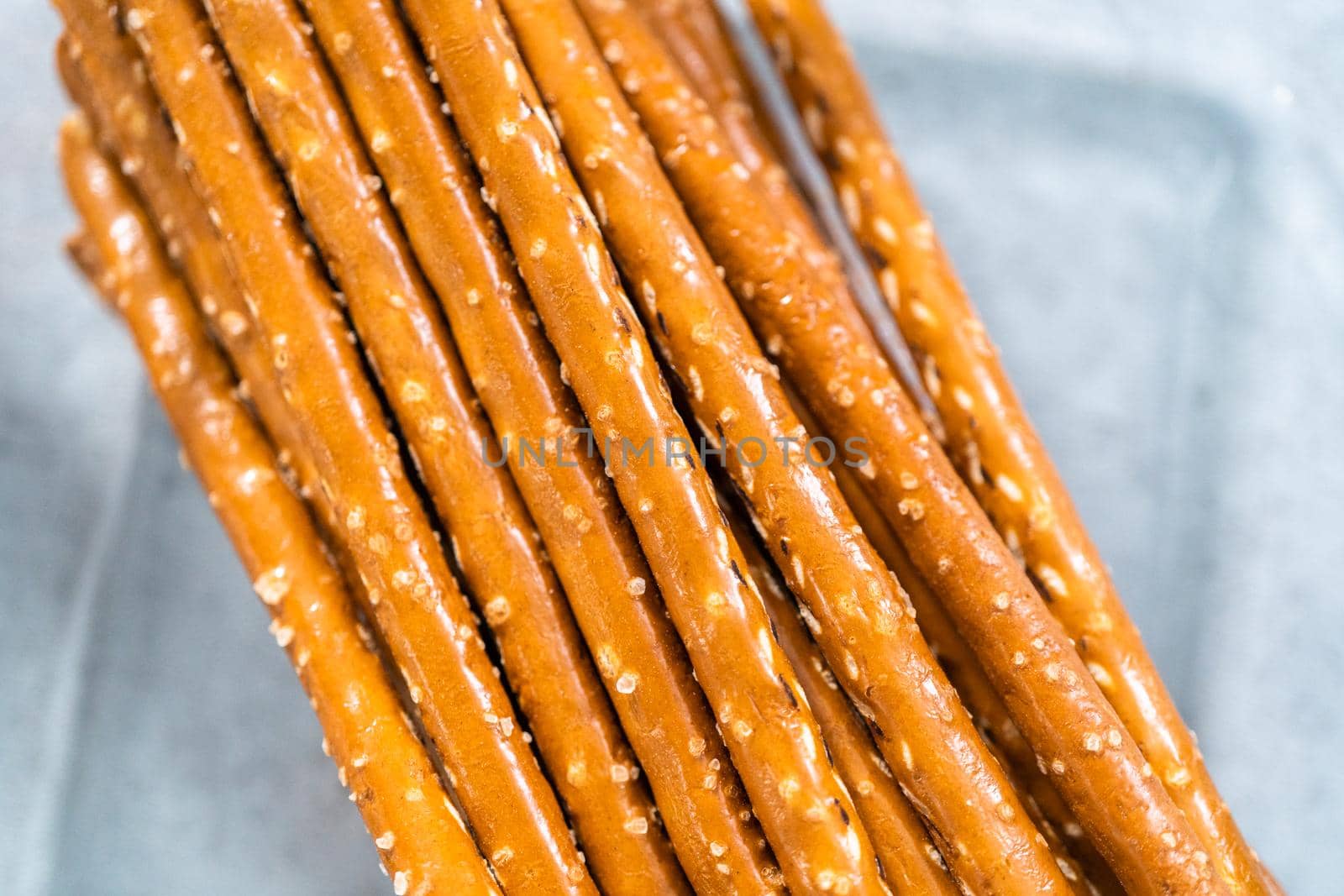 Ingredients in glass mixing bowls to prepare carrot chocolate covered pretzels.