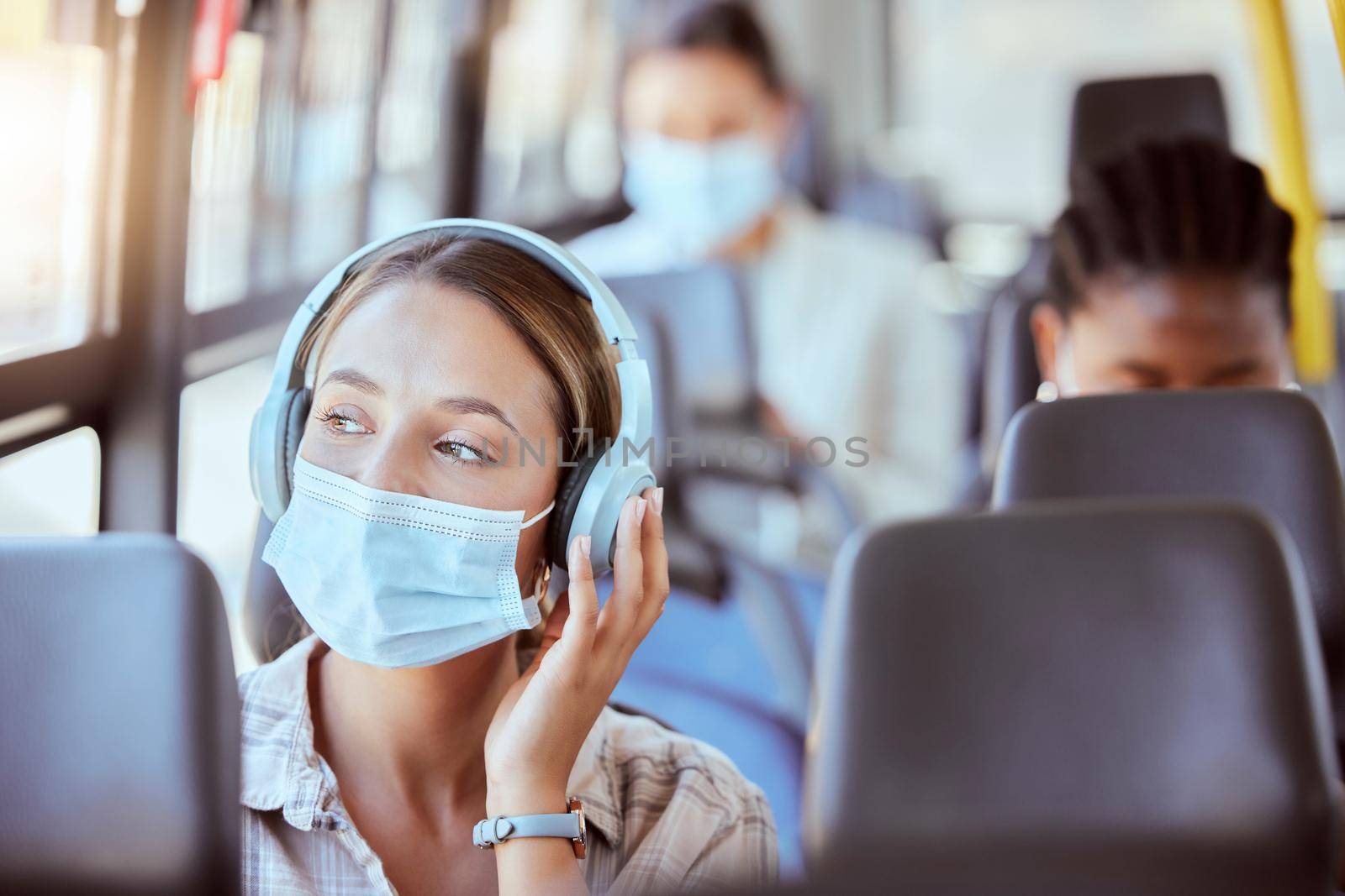 Covid, bus and woman with face mask and headphones listening to podcast on safety compliance, freedom or health risk. Girl city travel or transportation and music for corona virus radio news update.
