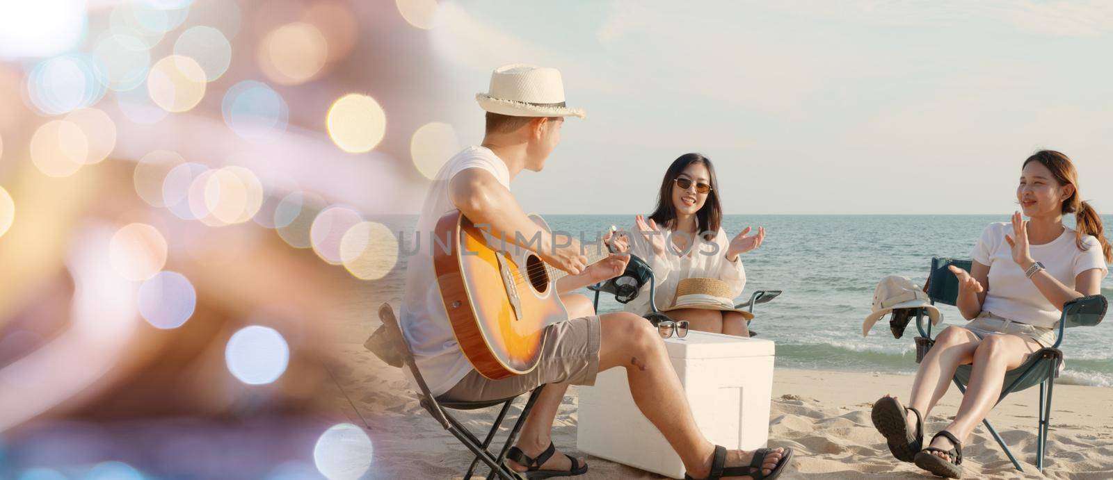 Happy friend have fun playing guitar and clap in camp they smiling together in holiday on sand beach near camping tent by Sorapop