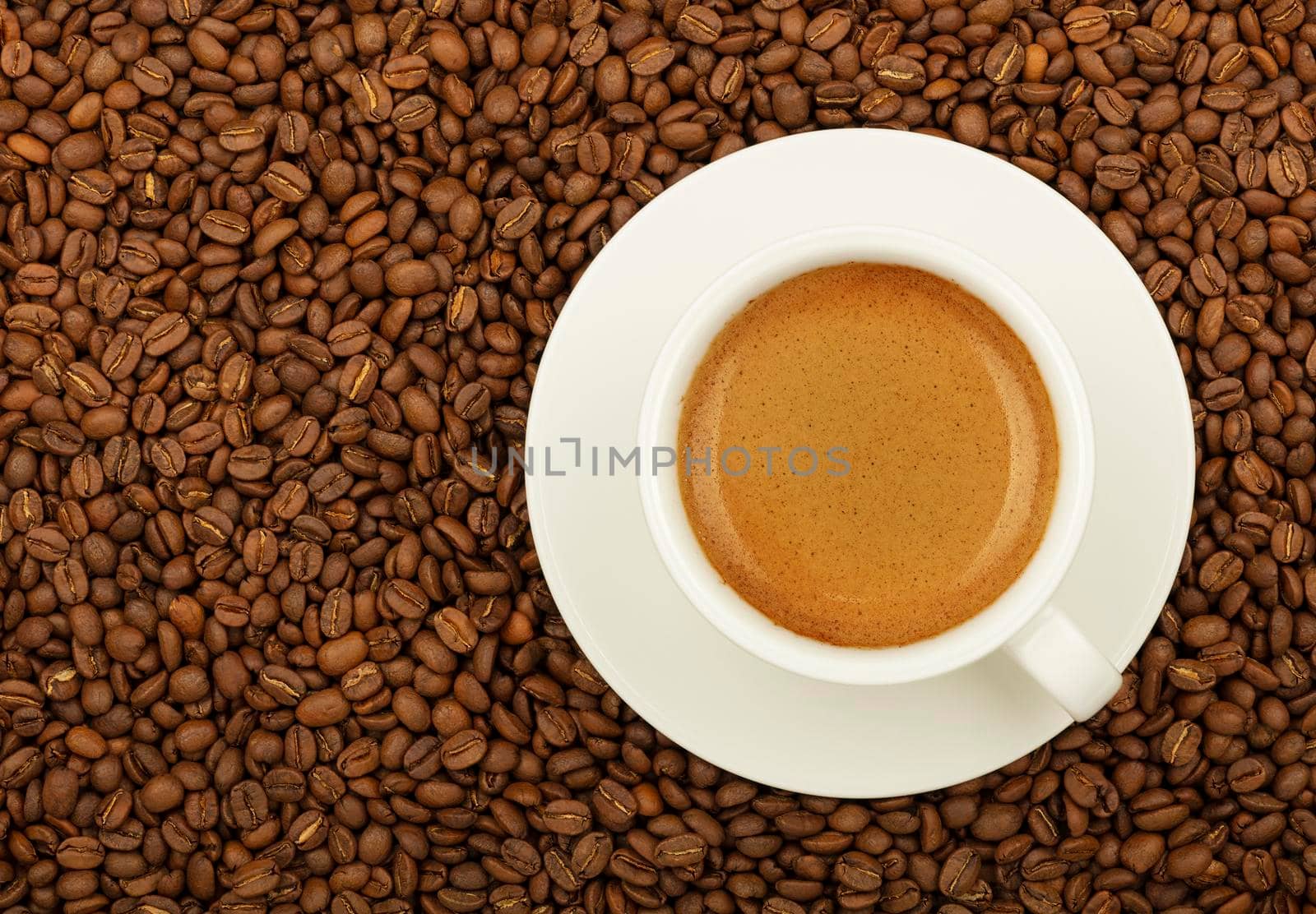 White cup espresso over roasted coffee beans by BreakingTheWalls