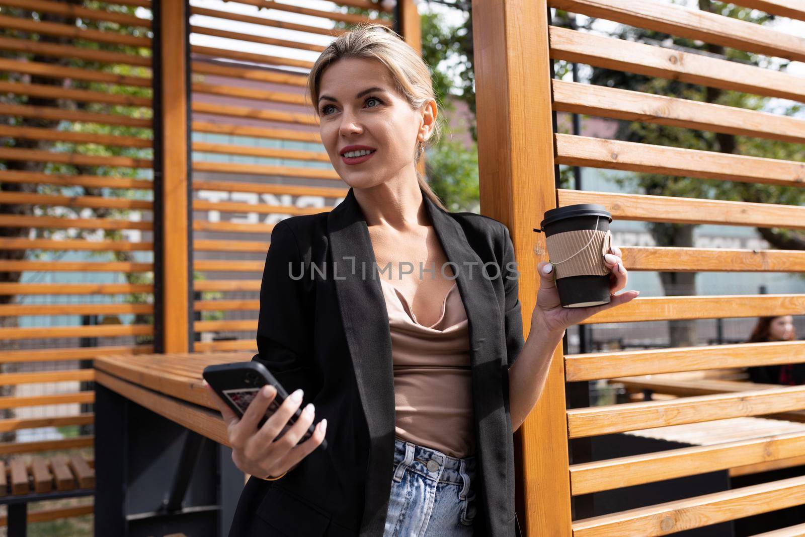 young successful business woman in a cafe with a mobile phone.