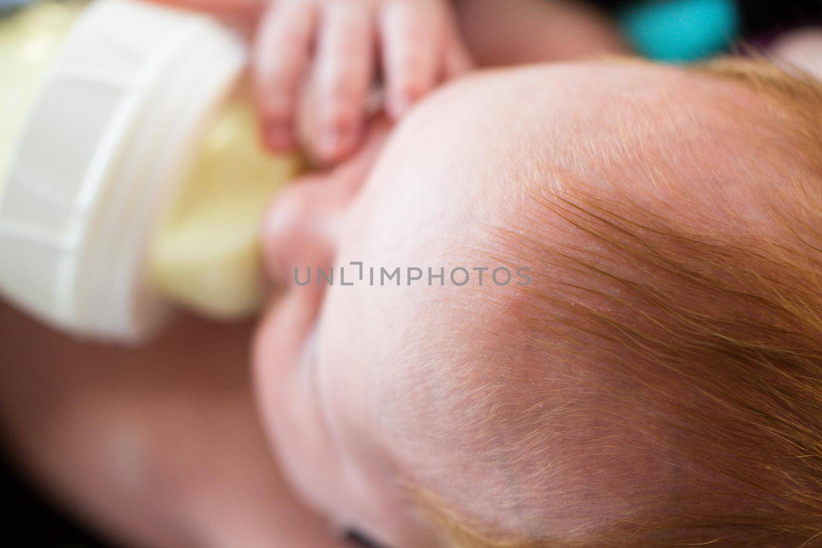 Newborn baby girl at feeding time.