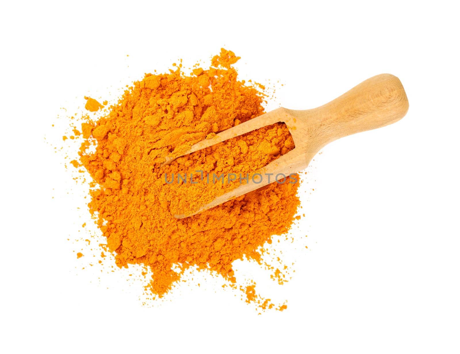Close up one wooden scoop full of yellow turmeric spice powder spilled and spread around isolated on white background, elevated top view, directly above
