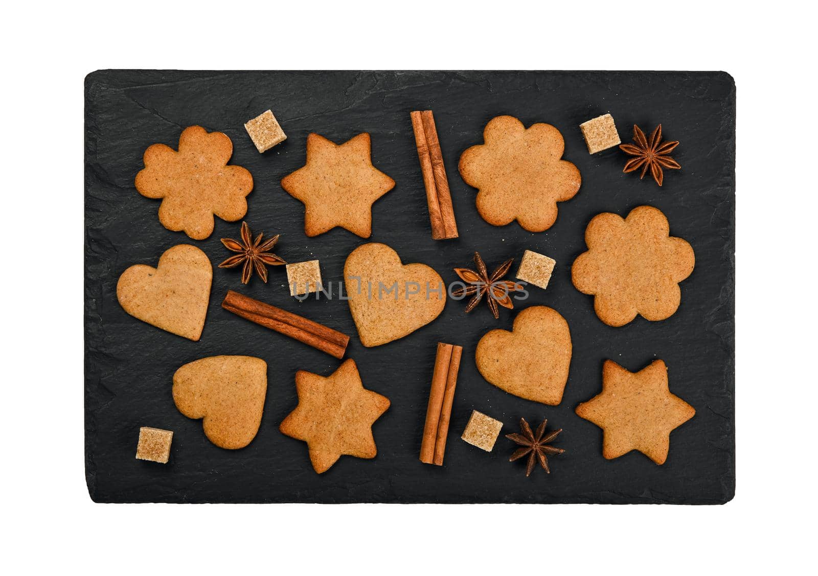 Gingerbread cookies and spices on black slate by BreakingTheWalls