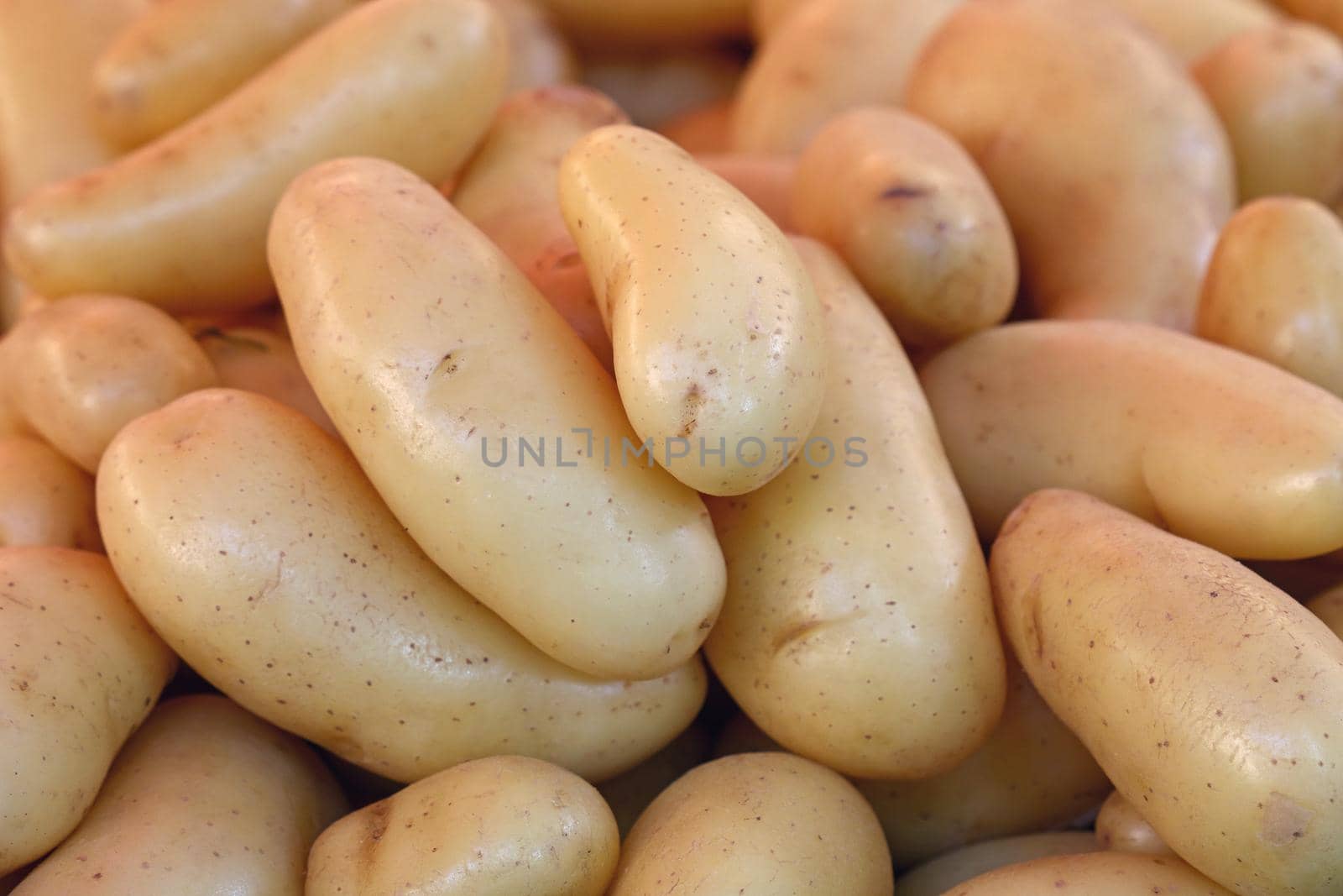 Close up heap of new potato at retail display by BreakingTheWalls
