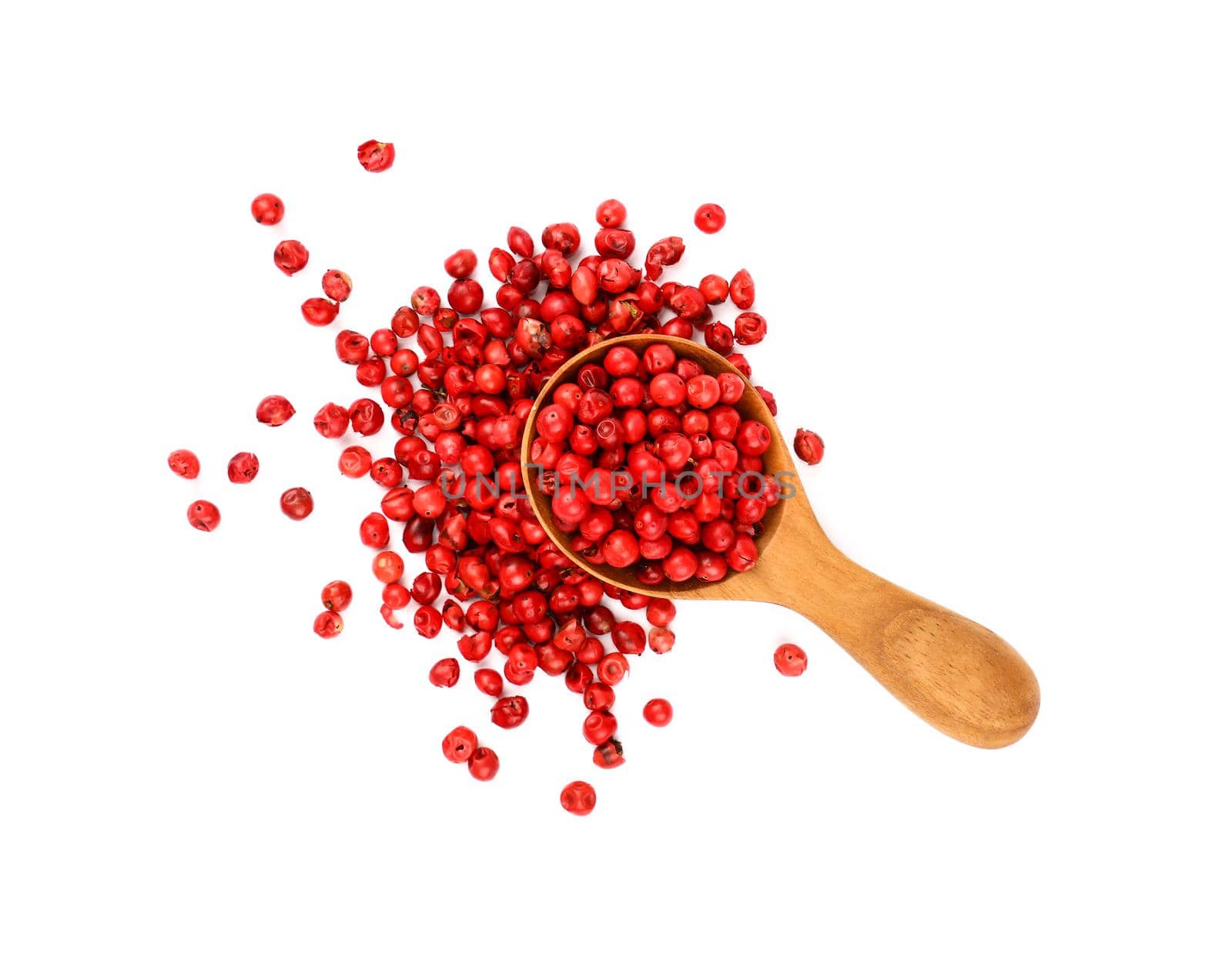 Wooden scoop spoon full of pink peppercorns by BreakingTheWalls