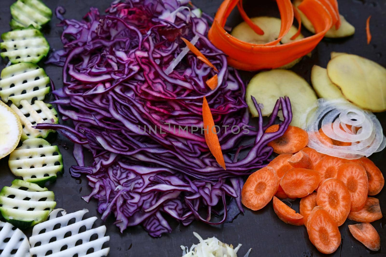 Assorted cut sliced vegetables on cooking board by BreakingTheWalls