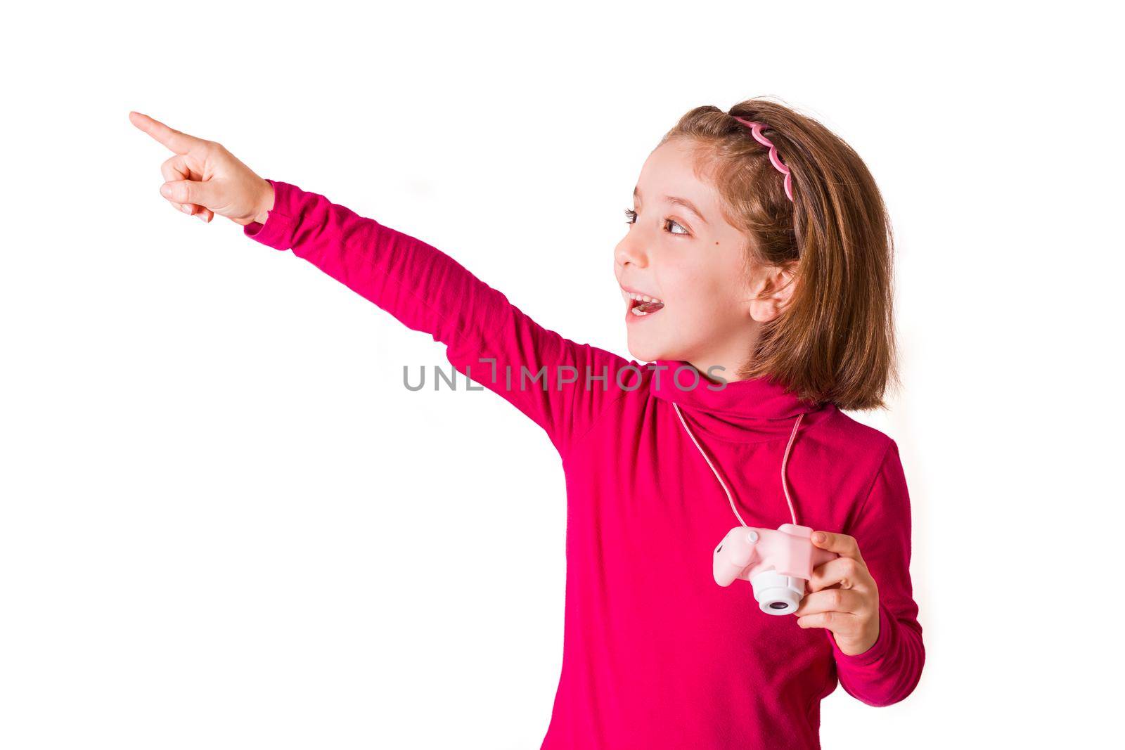 The little girl wearing red sweatshirt indicates with her finger where to photograph with her toy camera. High quality photo isolated on white