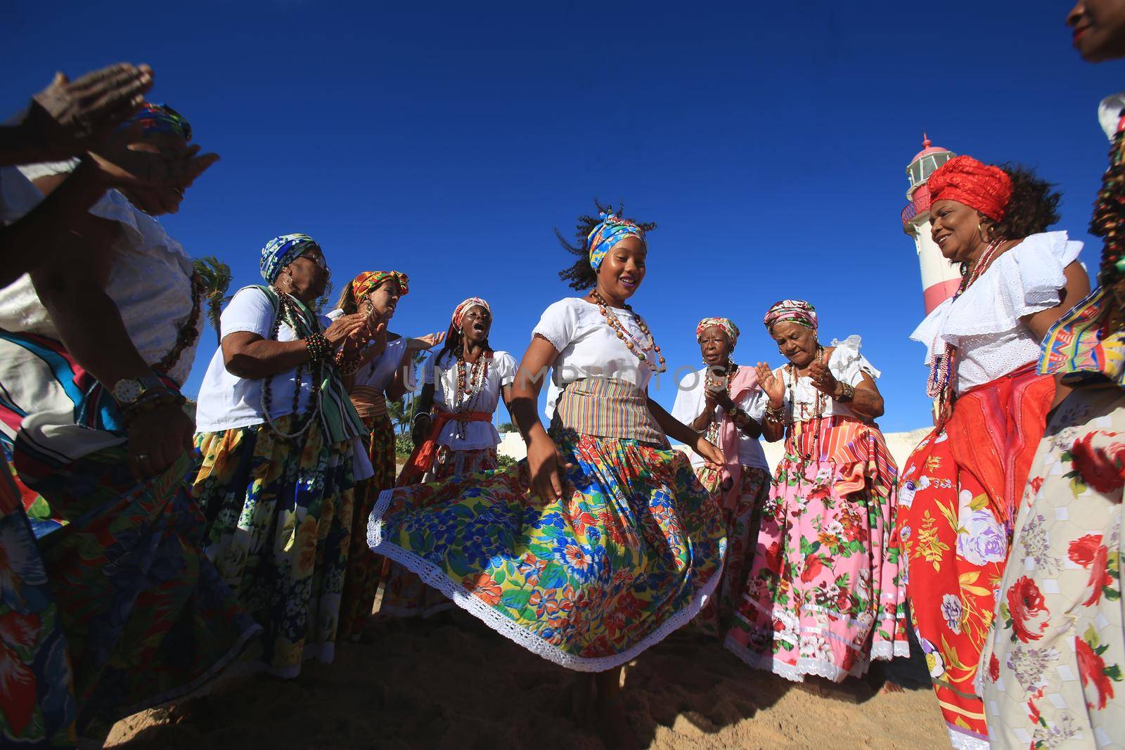 salvador, bahia, brazil - march 2, 2017: Members of the cultural group As Ganhadeiras de Itapua are seen at Farol de Itapua in the city of Salvador. 