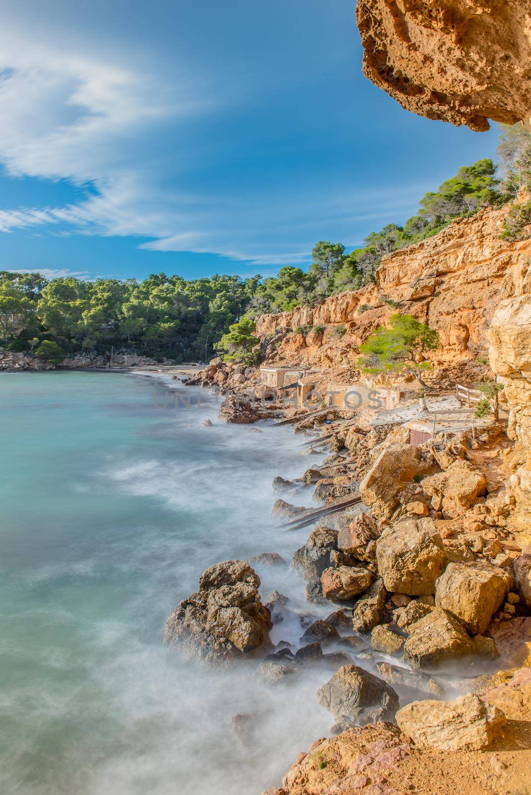 Cala Salada and Saladeta in san Antonio Abad at Balearic Islands Spain. Typical house for fishing boats and rocks. by martinscphoto