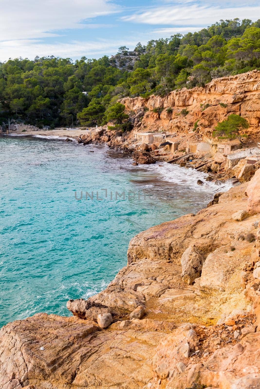 Cala Salada and Saladeta in san Antonio Abad at Balearic Islands Spain. Typical house for fishing boats and rocks. by martinscphoto