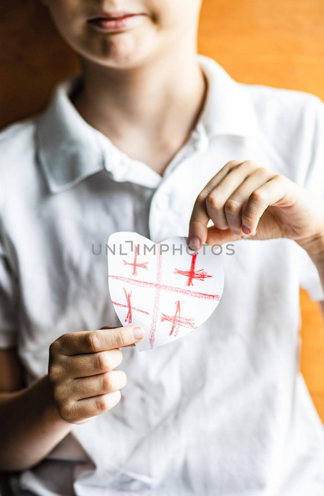 Kid hands with heart shaped Georgian flag
