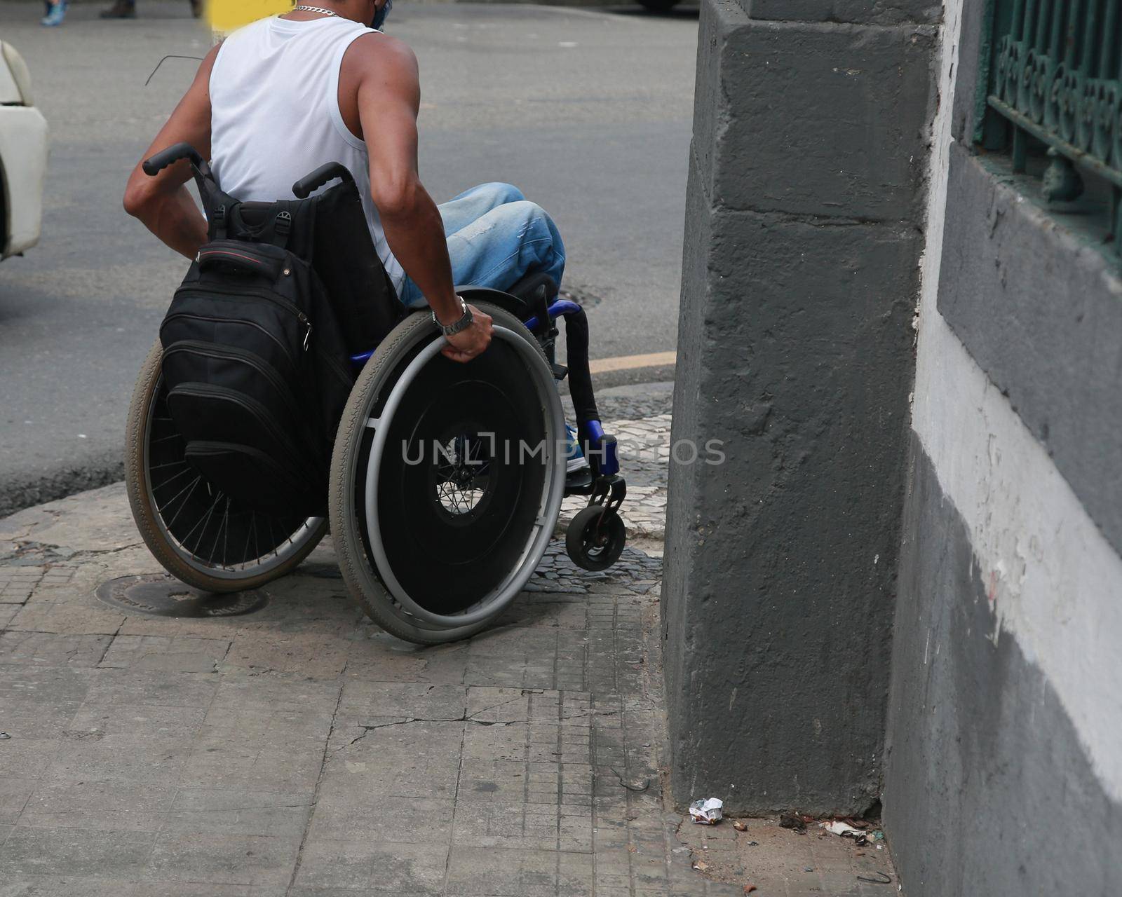 salvador, bahia, brazil - december 2, 2021: wheelchair user in a street in the center of the city of Salvador.