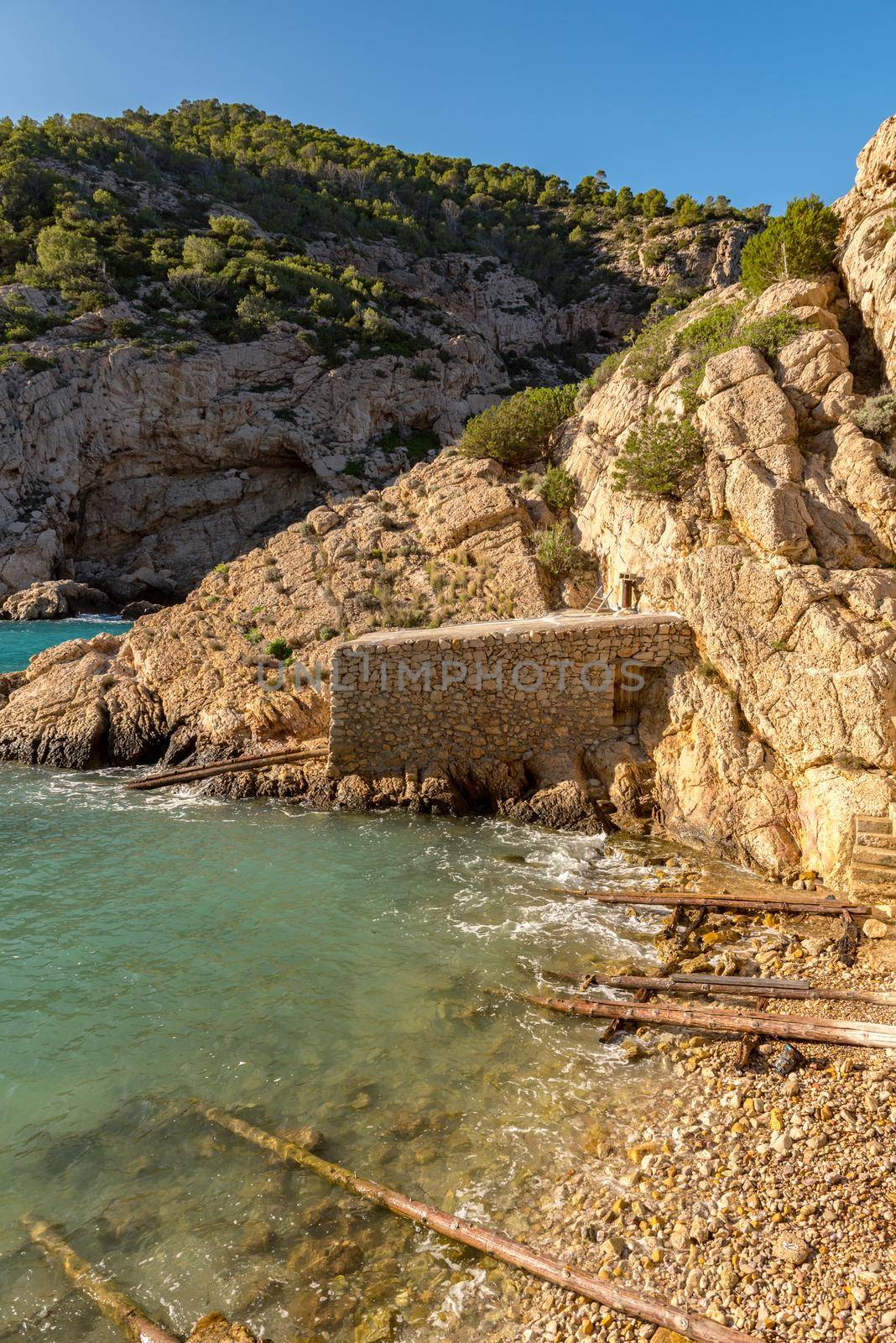 Turquoise waters in Es Portitxol, Ibiza, Spain. Hidden bay on the Island of Ibiza, in Sant Joan de Labritja. by martinscphoto