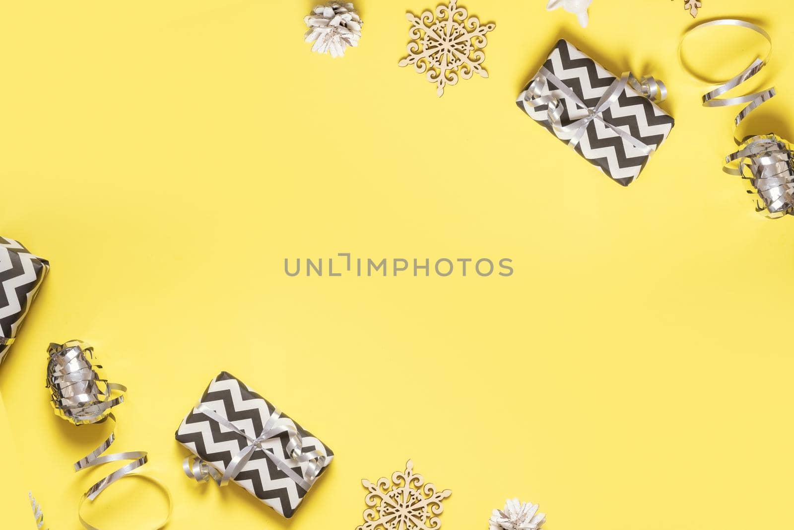 christmas flat lay composition from gift boxes, pine, cones on colored background top view. Copy space by ssvimaliss