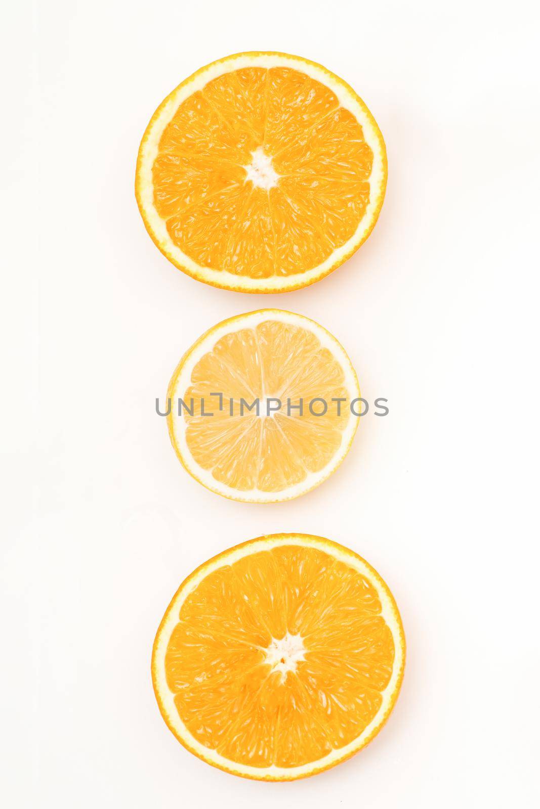 Flat lay of the three orange slices lying isolated on white background