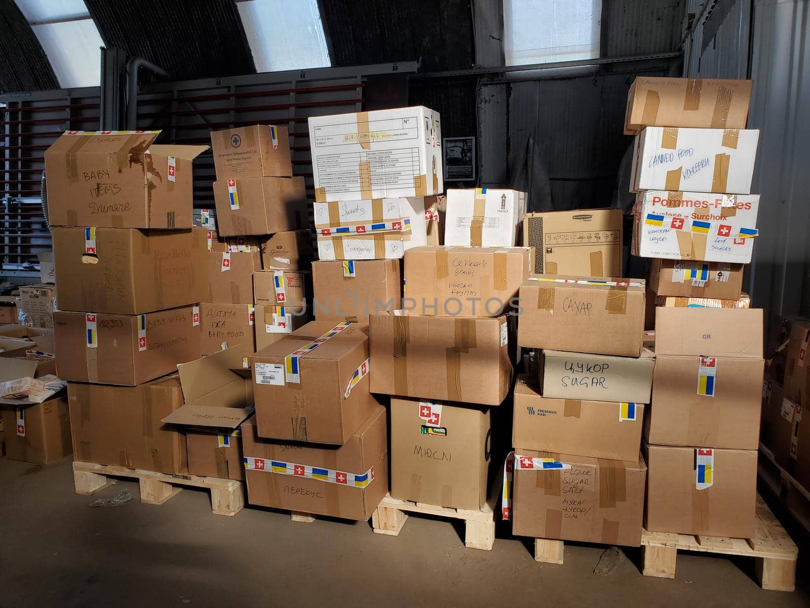 Boxes with humanitarian aid for Ukraine in volunteer centre warehouse. Dnipro, Ukraine - 06.30.2022
