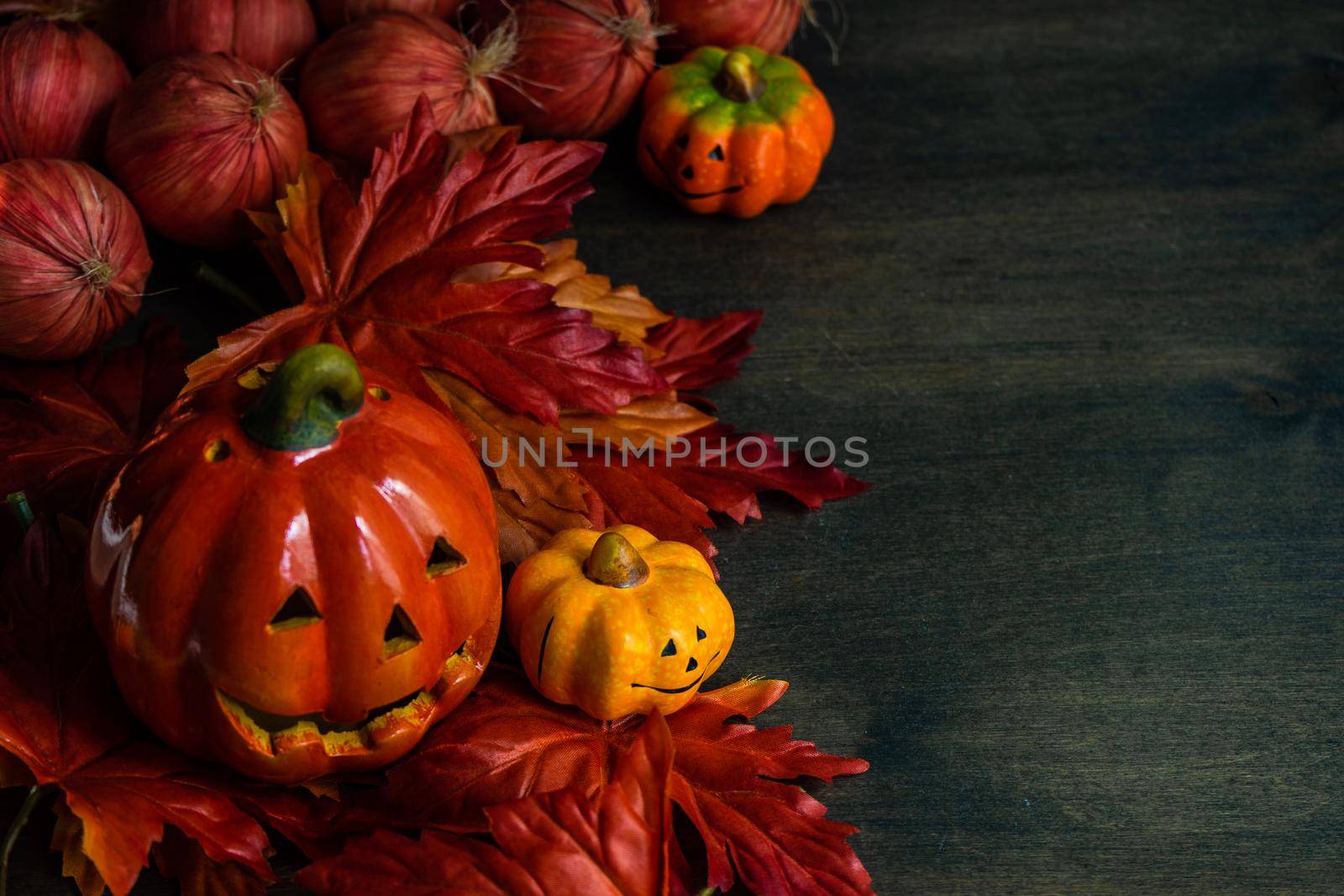 Autumnal flat lay with leaves and pumpkins on wooden background