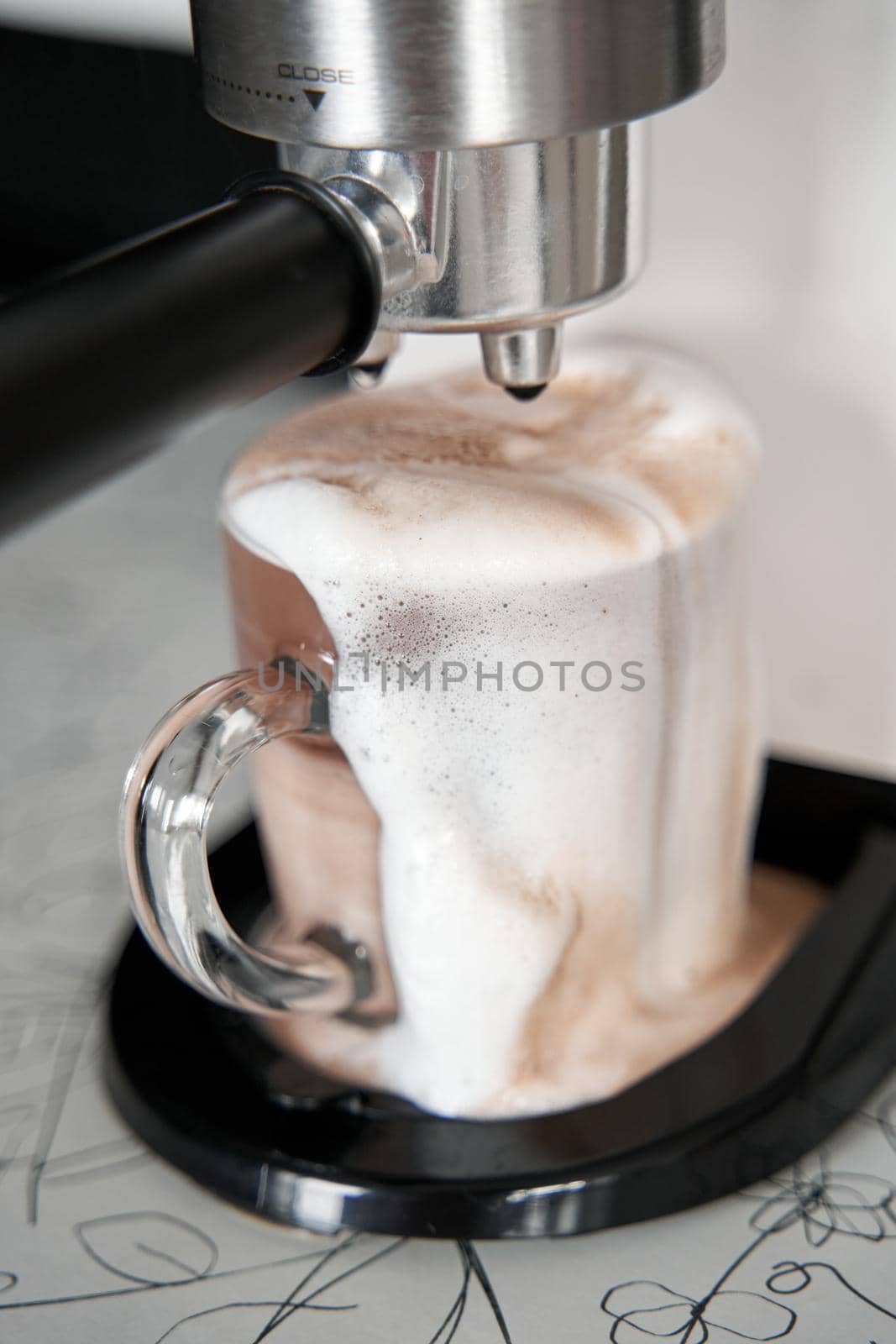 Coffee machine overfilled cup with coffee close up.