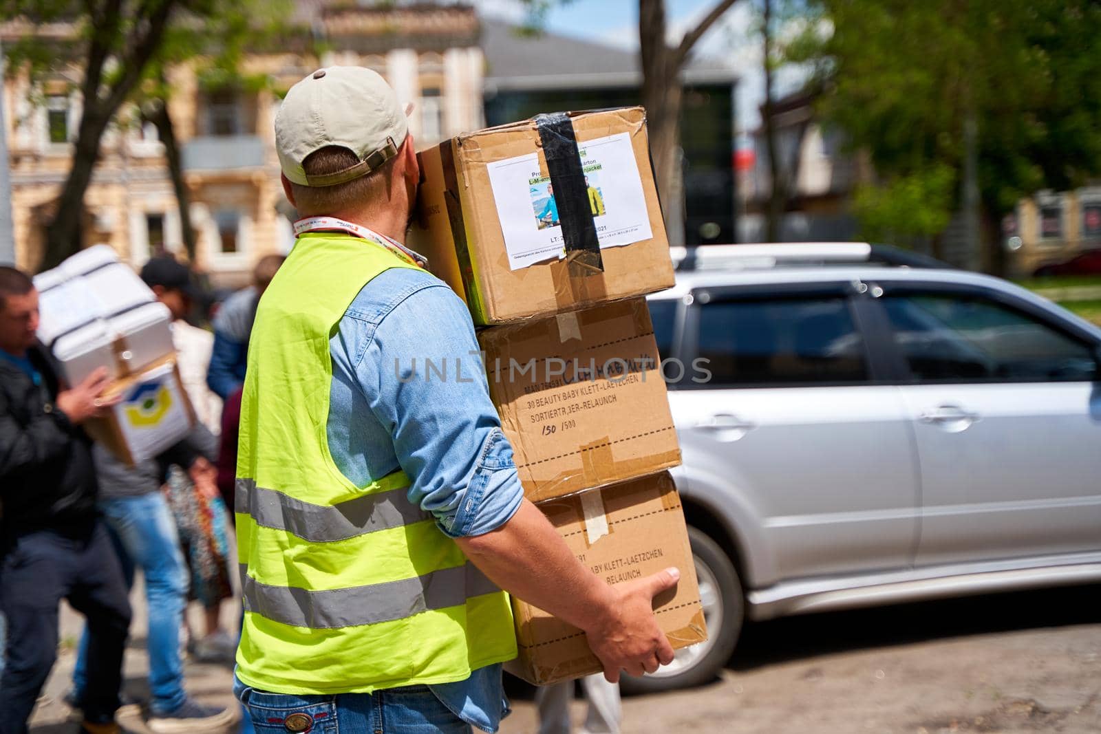 Ukrainian volunteers unloading boxes with humanitarian aid. Dnipro, Ukraine - 06.30.2022