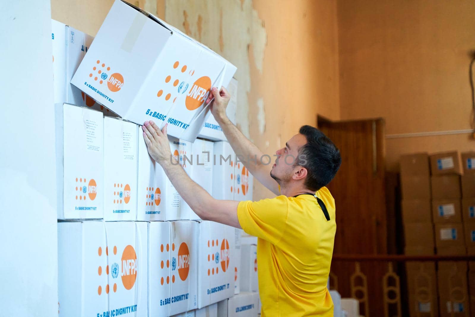 Volunteer sorting out boxes with humanitarian aid. Dnipro, Ukraine - 06.30.2022