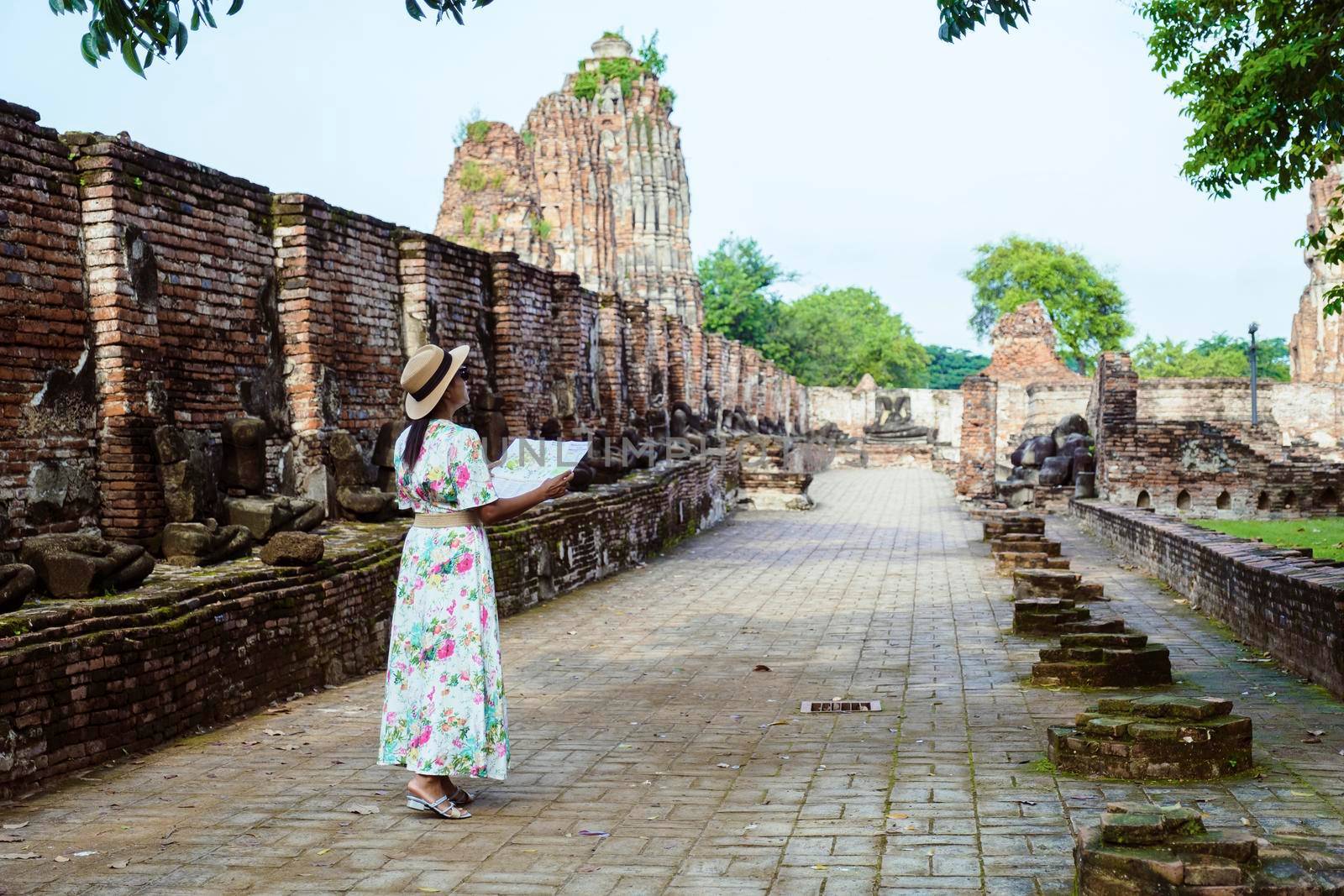 Ayutthaya, Thailand at Wat Mahathat, women with a hat and tourist map visiting Ayyuthaya Thailand by fokkebok