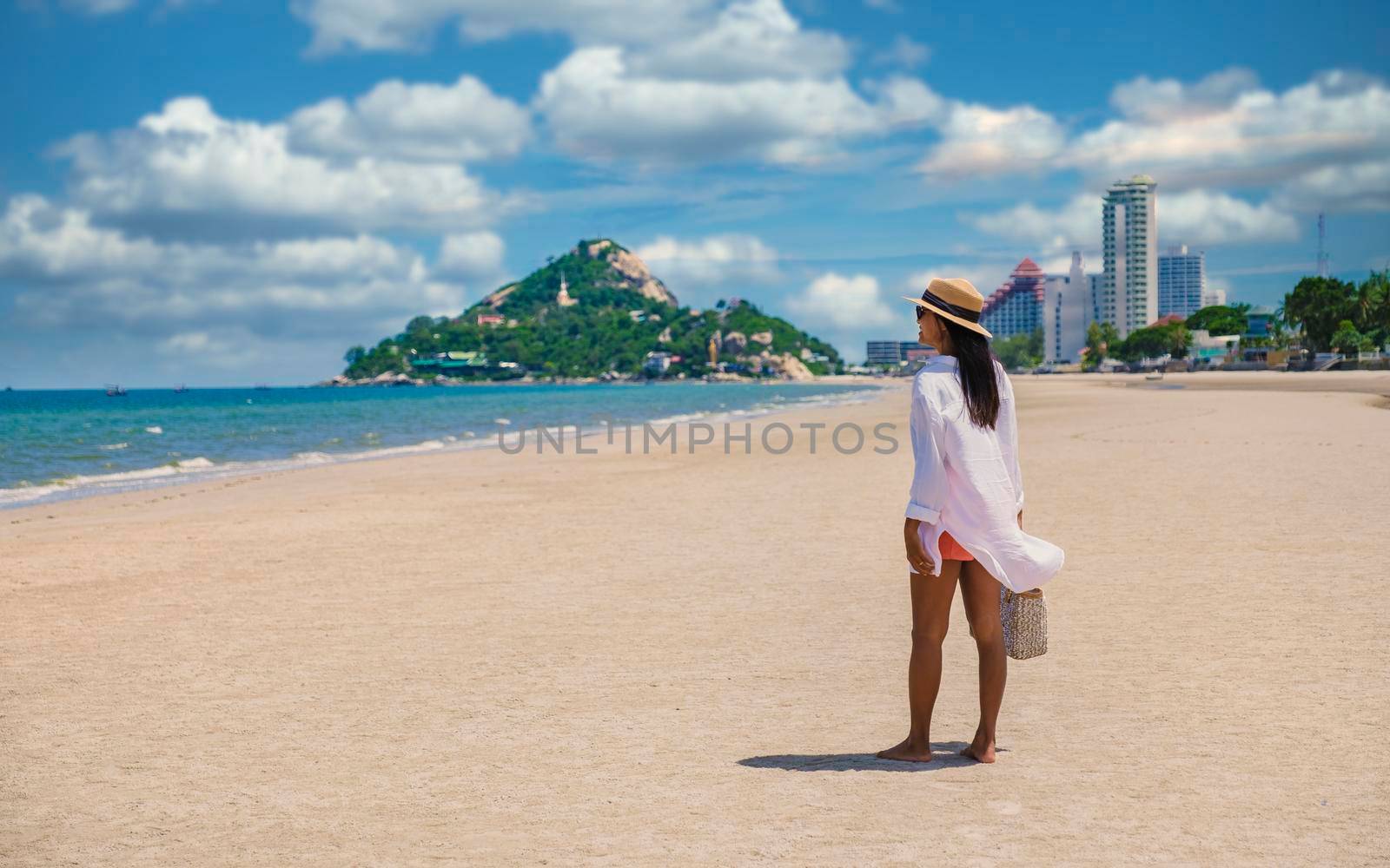 Takiab Beach Huahin Thailand, Asian women walking on the beach in the morning by fokkebok