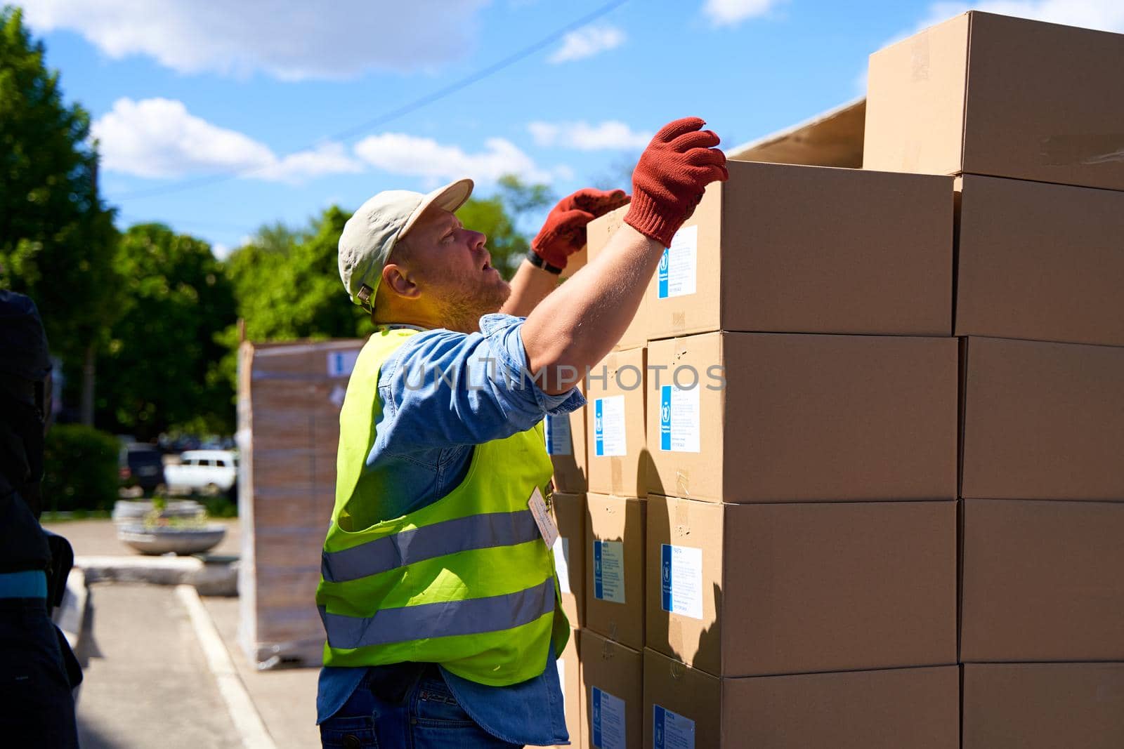 Ukrainian volunteers unloading boxes with humanitarian aid. Dnipro, Ukraine - 06.30.2022