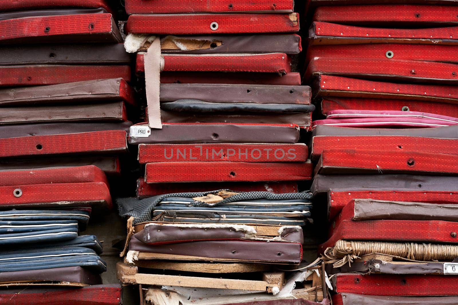 Bunch of old broken chair seats on backyard of theatre.